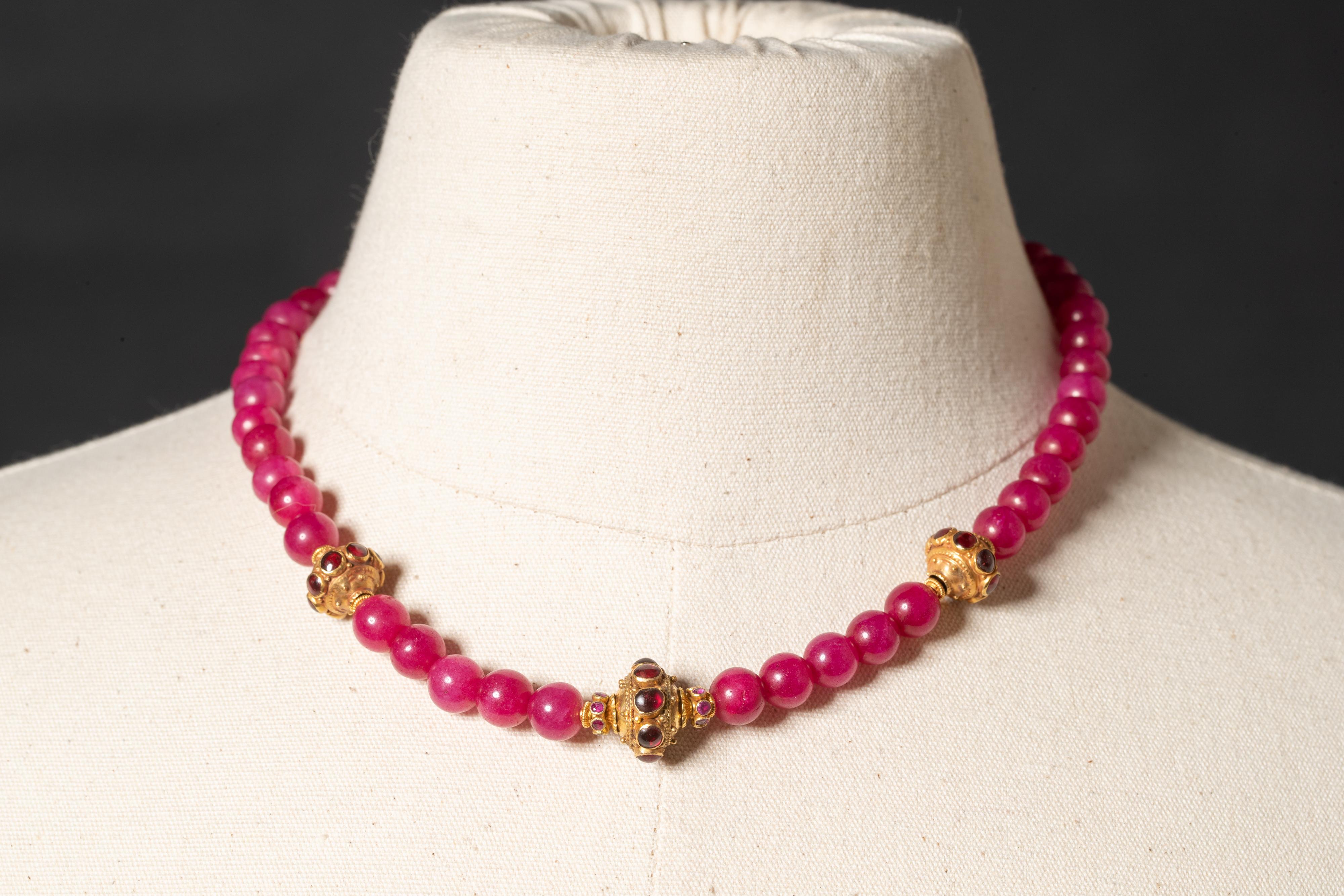 A lovely Burmese ruby necklace punctuated with 22K gold beads with cabochon rubies and a 22K gold S-hook clasp.  Burmese rubies tend to be more pink than the more traditional ruby.  Rubies are 8mm. By Deborah Lockhart Phillips