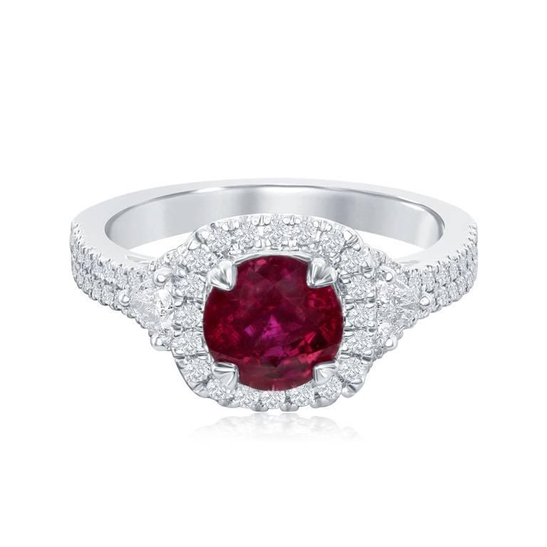 This classy and timeless ring features a beautiful and sparkly round ruby.  The ruby is surrounded by shiny brilliant cut diamonds.  This ring also has beautiful trillion cut diamond accents with round diamonds going down a split shank.
Metal:  14k