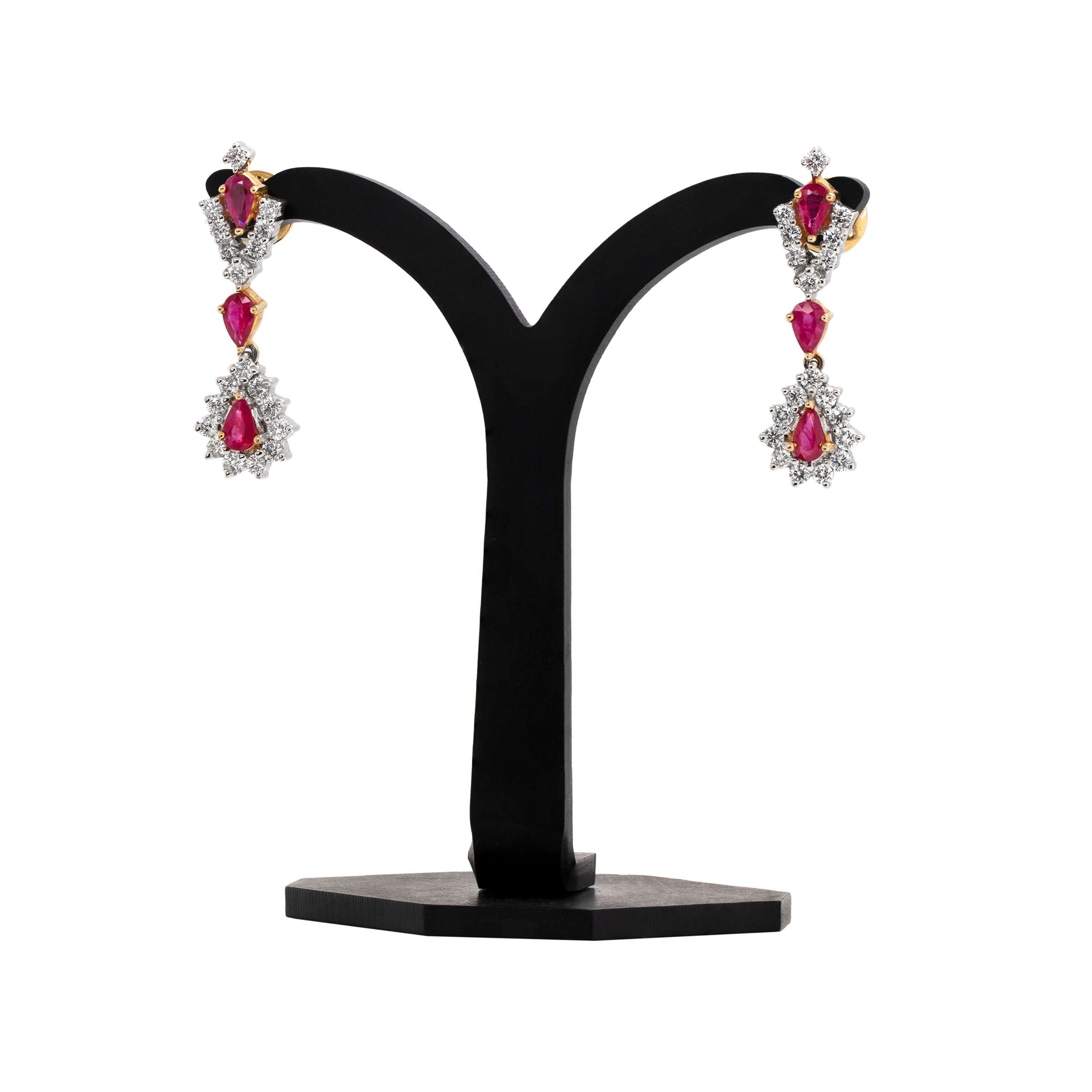 These exquisite drop earrings are beautifully set with three pear shaped rubies in each, weighing an approximate total weight of 1.30ct, all mounted in 18 carat yellow gold. The rubies are wonderfully accompanied by 19 round brilliant cut diamonds