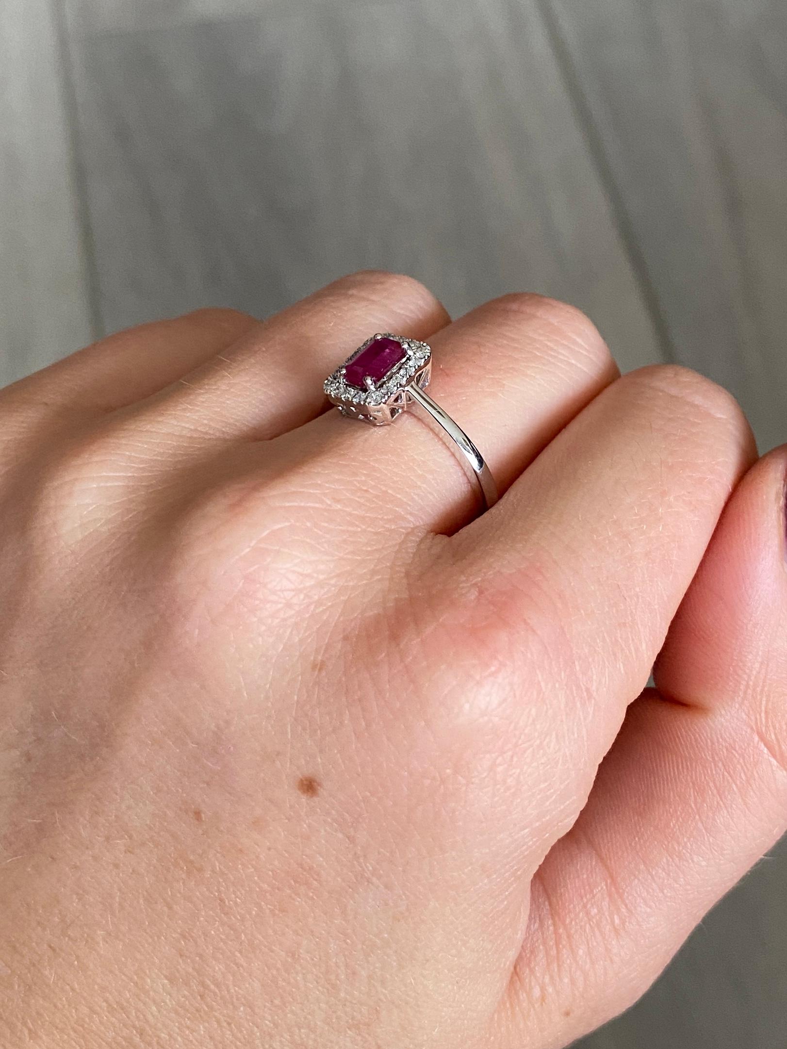 This stunning cluster holds a bright pink ruby at the centre measuring 20pts and around the outside is a halo of sparkling diamonds totalling approx 40pts. The ring is modelled in 18 carat white gold.

Ring Size: O or 7 1/4
Cluster Diameter: