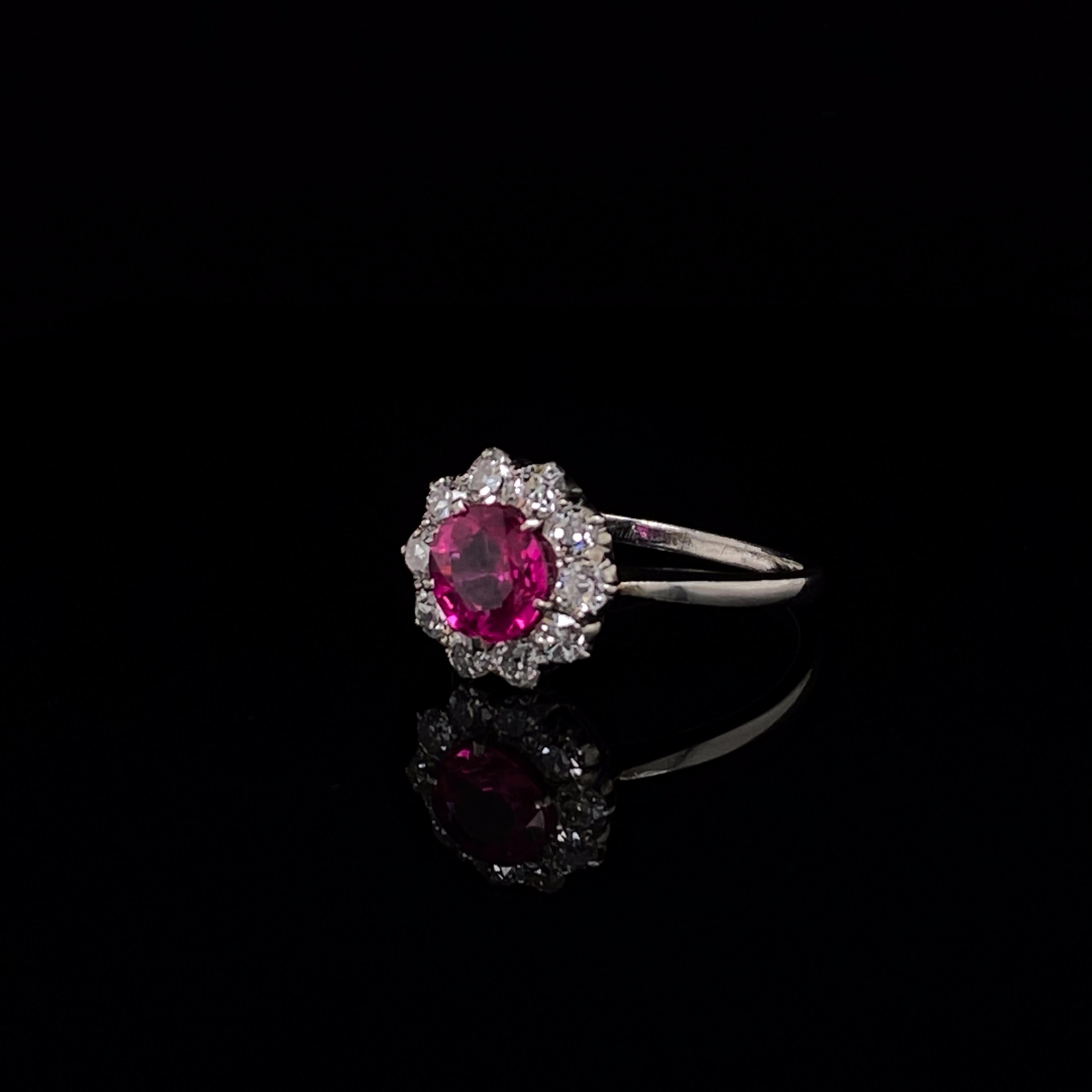 Ruby and diamond 18 karat white gold cluster engagement ring circa 1900.

Such a pretty ring set with a rich, lively ruby centre and old cut diamond surrounds. The 18 karat white gold band tapers towards the ruby and diamond cluster with an open