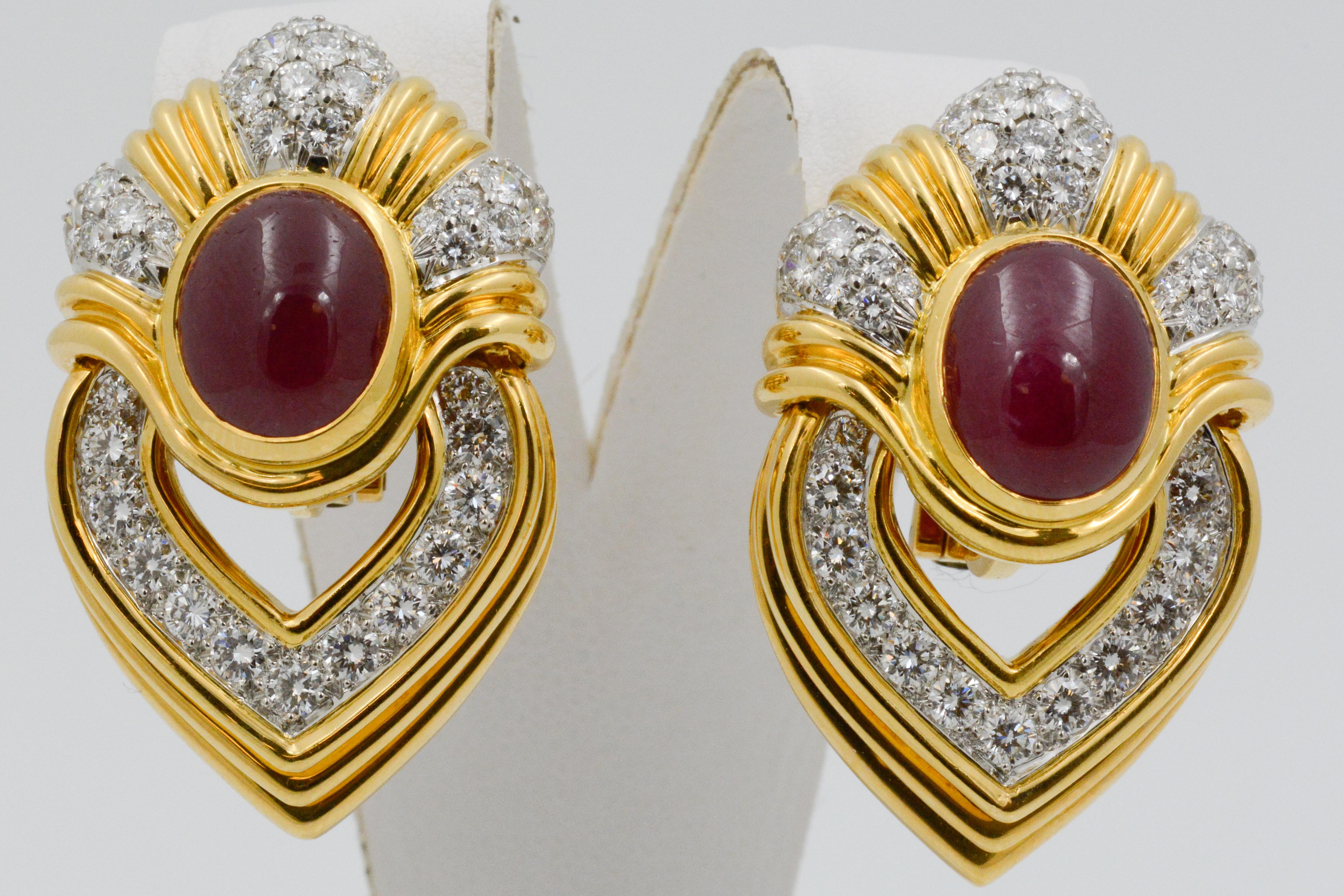 These vibrant door knocker earrings feature oval cabachon cut rubies, weighing a total of 14 carats. The rubies are accented by accented by round brilliant cut diamonds, weighing a total of 2.50. The earrings have an alternating pattern of round