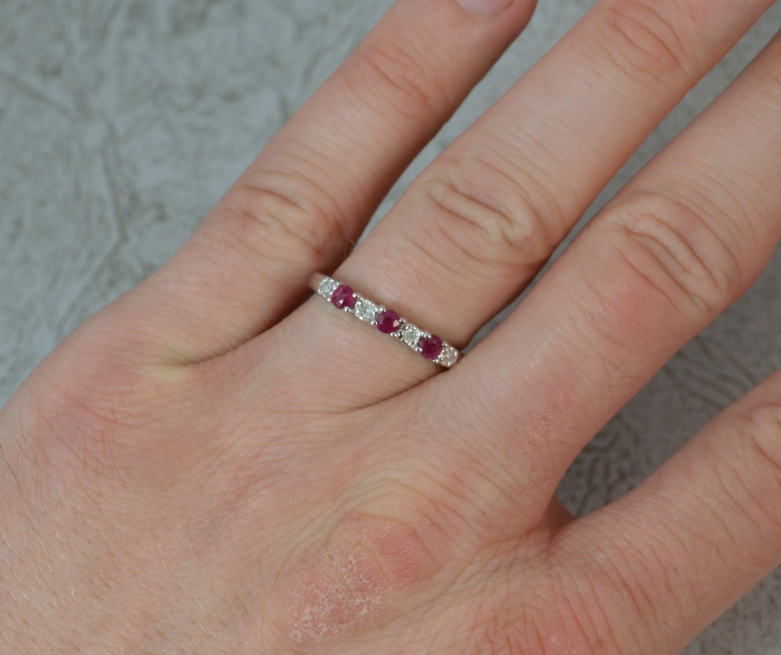 A quality Ruby and Diamond ladies half eternity ring. Solid 9 carat white gold example with claw setting.
​Set with alternating round cut natural ruby and diamond stones.
​18mm spread of stones. 2.8mm wide band to front.

Condition ; Excellent.