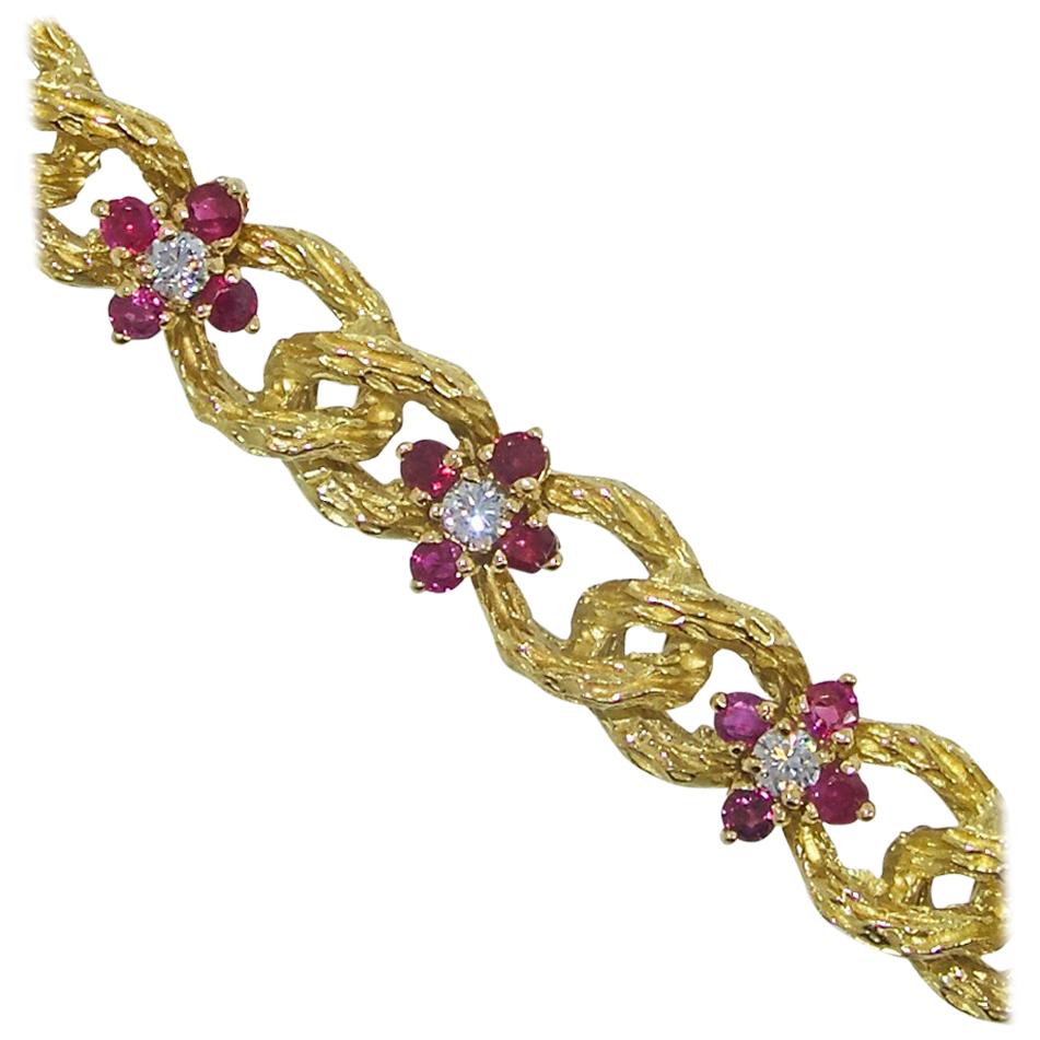 Bracelet in 18K yellow gold, 44 natural fine Rubies, weighing totally approximately 1.32 cts. and 11 fine white diamonds weighing totally approximately .88 cts.  This contemporary bracelet is 7.25 inches long and very well made with an invisible