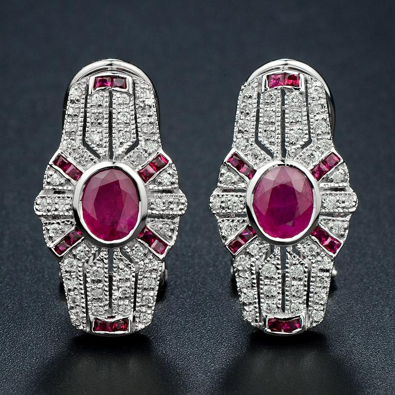 A vibrant oval ruby at the center, surrounded by a halo of sparkling diamonds. Flanked by ruby at each corner and along the top and bottom, creating a bold and elegant design. The intricate details and geometric shape exude timeless vintage glamour.