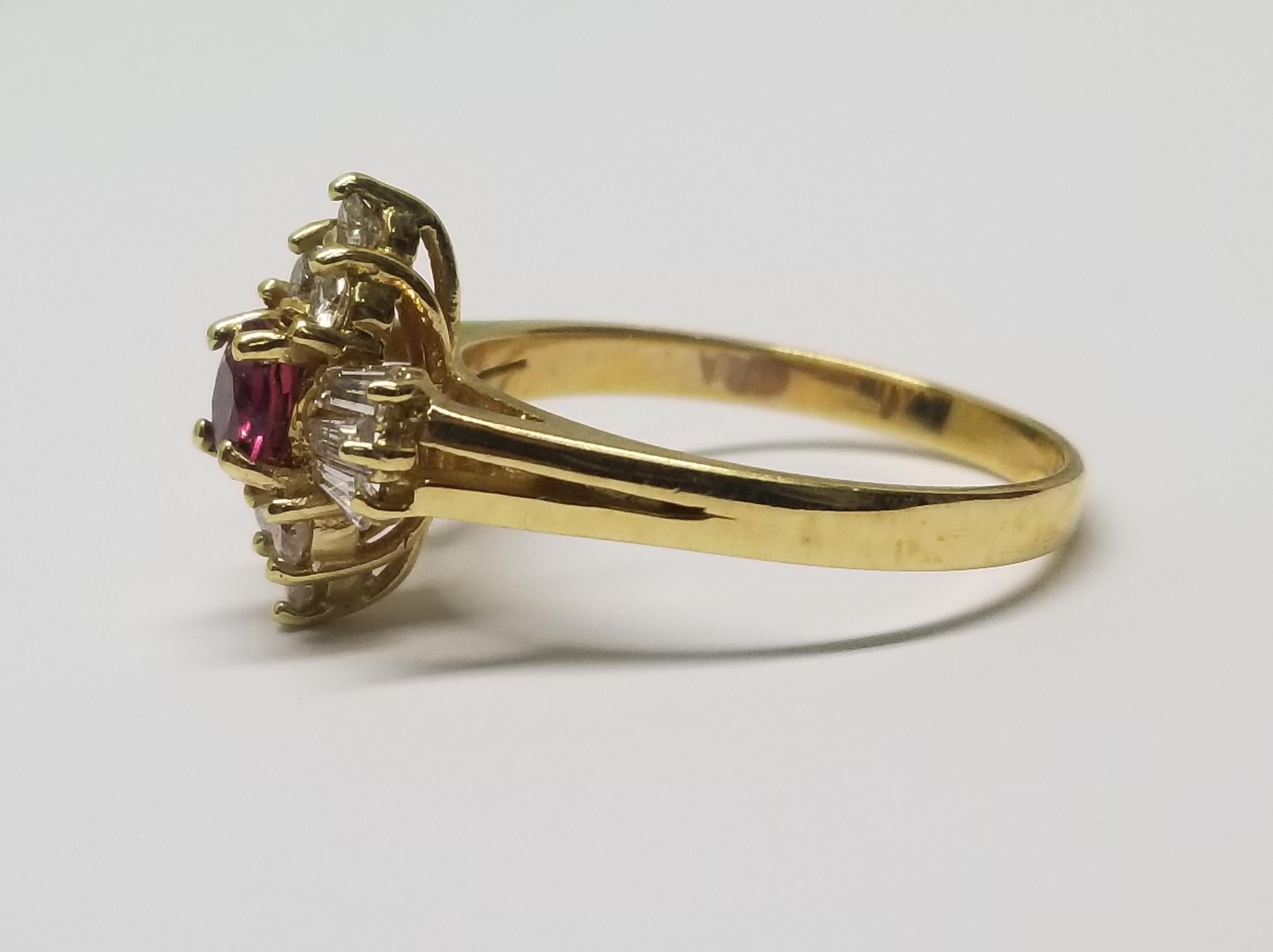14k yellow gold ruby and diamond ring, containing 1 round ruby of gem quality weighing .36pts. and 6 baguette cut diamonds weighing .22pts. and 6 round full cut diamonds weighing .20pts. all diamonds are of very fine quality.  This ring is a size