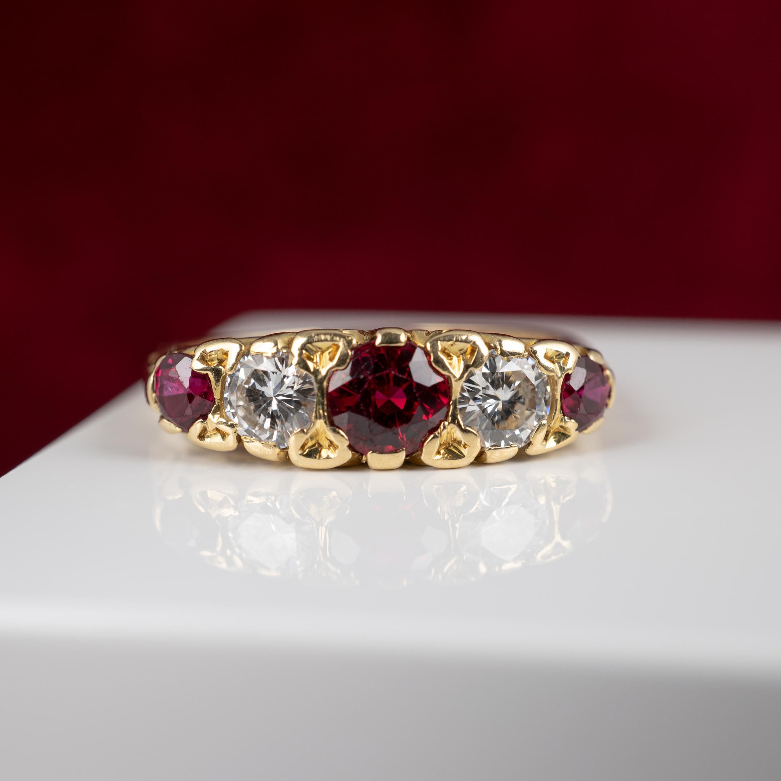 A fine quality ruby diamond band ring surmounted with 1.10 carats of the most gorgeous rubies and complimenting diamonds set within a scroll worked setting. The classic style ring is fully hallmarked and dated London 1974 and in fabulous