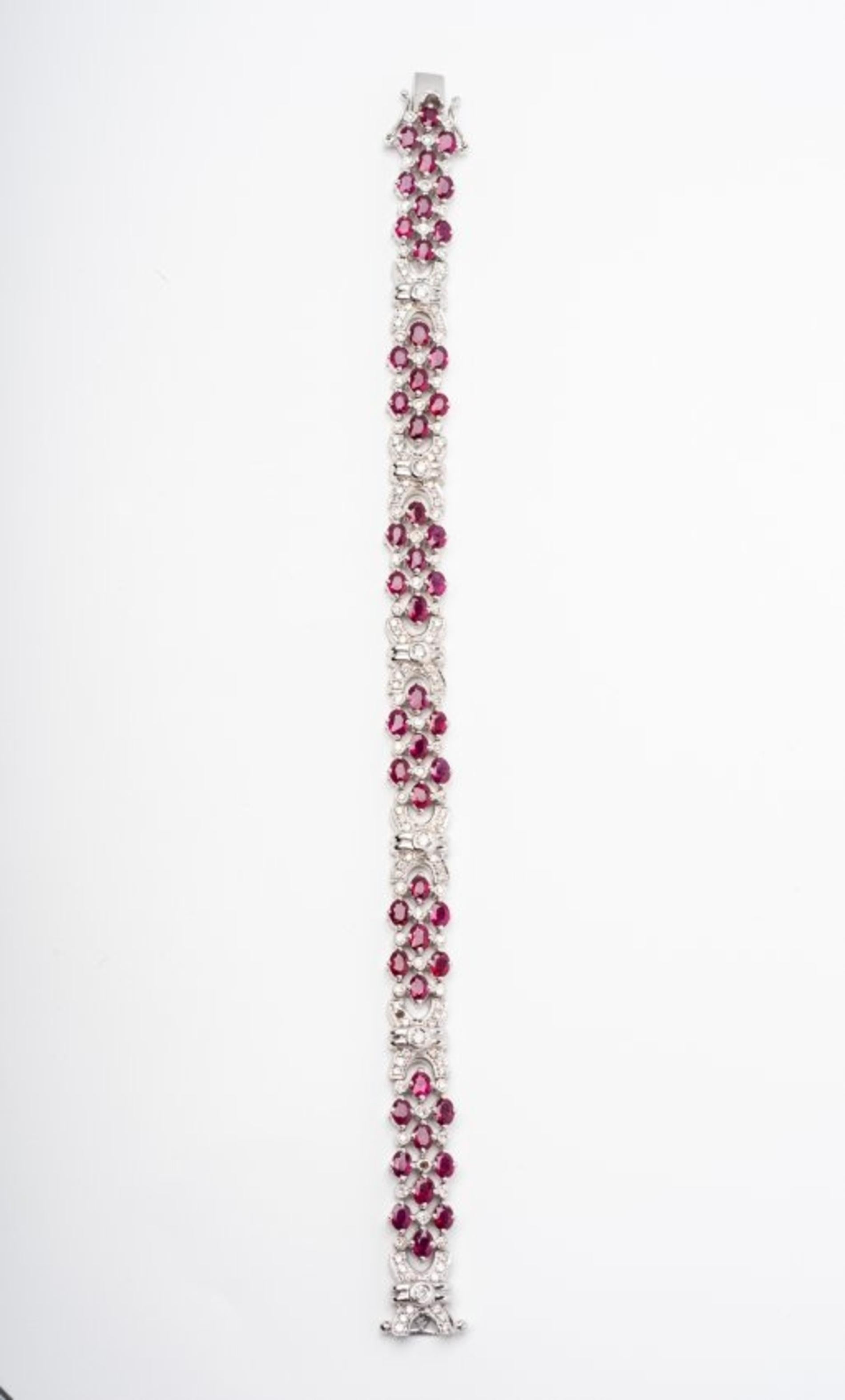 Ruby and Diamond Bracelet 
composed of numerous pear-shaped rubies and brilliant-cut diamonds, mounted in 18 karat white gold, length approximately 7 1/2 inches
gross weight approximately 20 dwts,