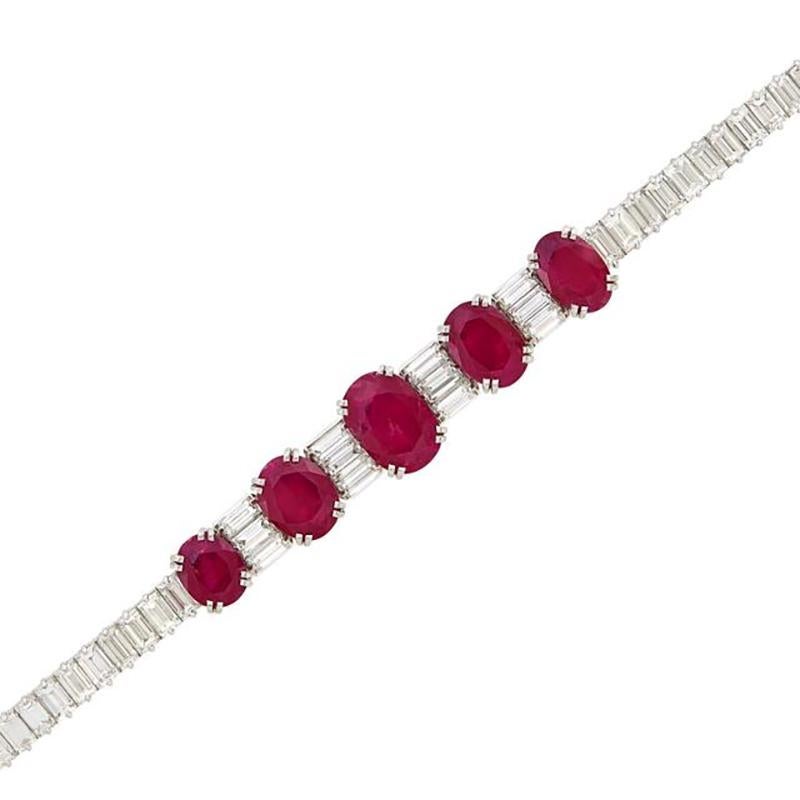 A Classic Ruby and Diamond Bracelet mounted on Platinum. Made in the USA, circa 1960.

The bracelet showcases 8 oval rubies approximately 14.25 cts., spaced by triplets and completed by lines of baguette diamonds approximately 10.00 cts. Total item