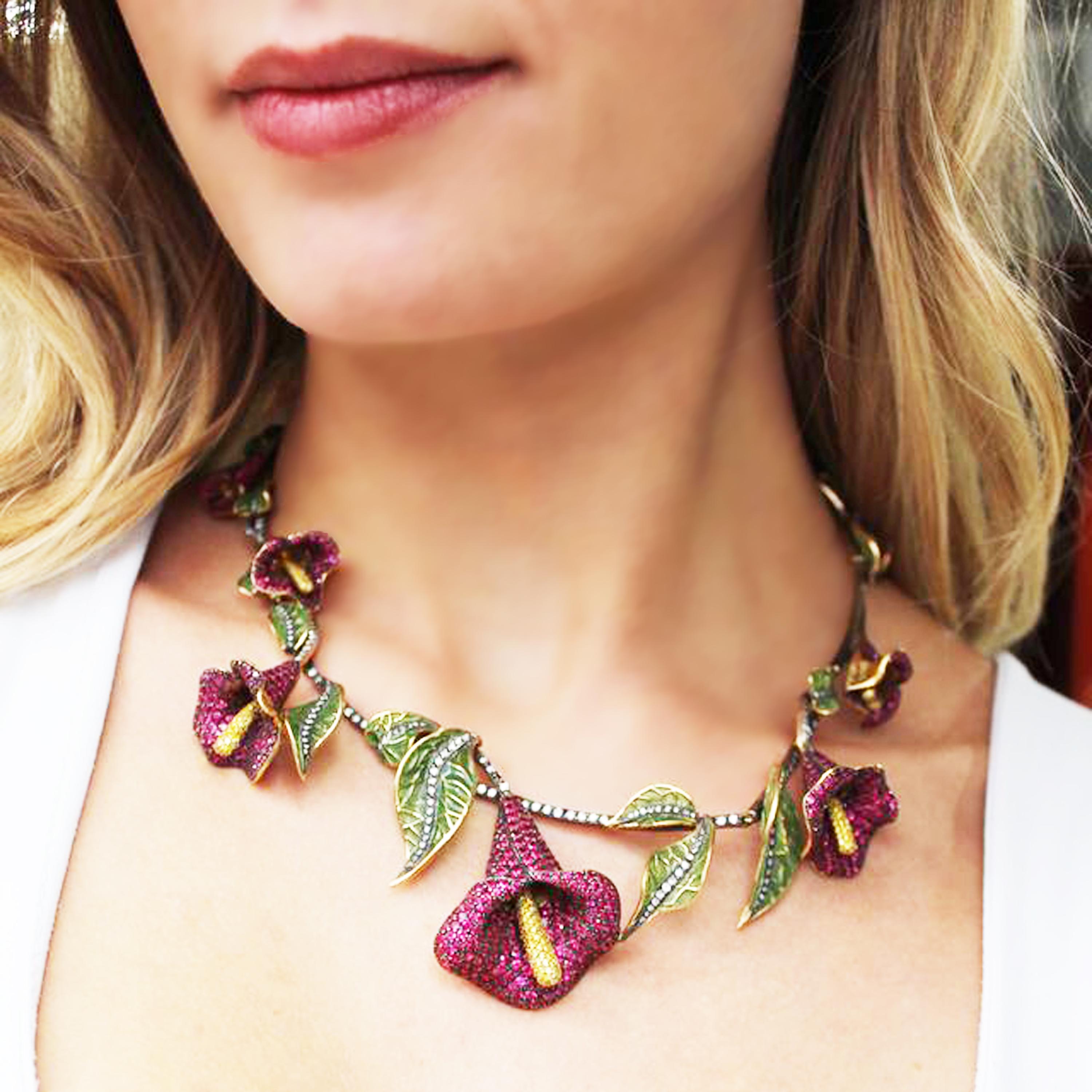A Moira design, ruby and diamond floral necklace, with calla lilies, pavé set with rubies, with yellow diamond set carpels and round brilliant cut diamonds set in the stems, with green, plique à jour enamel and diamond set leaves, mounted in