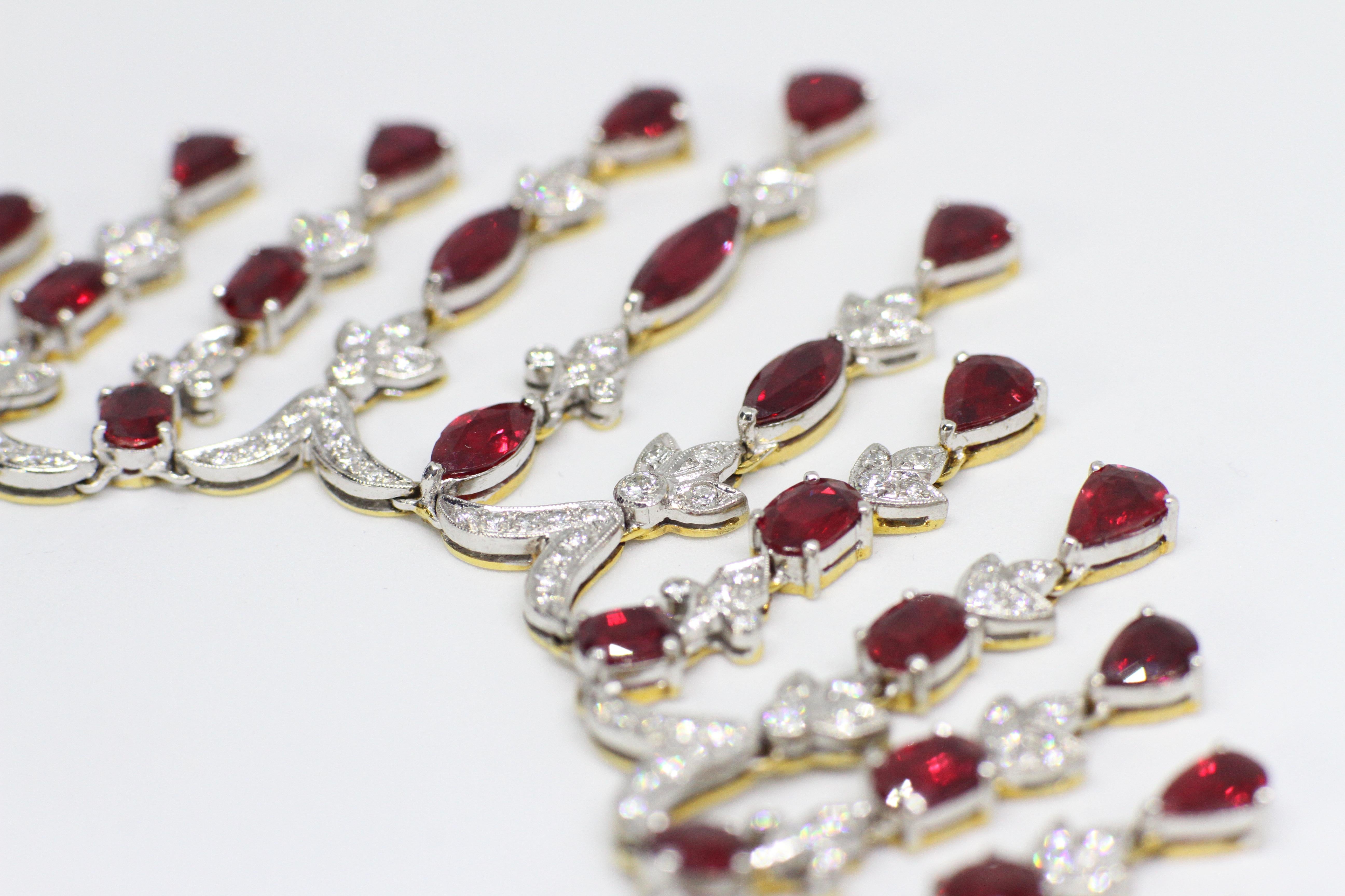 Spectacular ruby and diamond necklace and earring set all in 18 carat white and yellow gold. They are both set with a total of sixty nine rubies - a combination of marquise, pear shaped, round and oval shaped rubies with a minimum approximate total