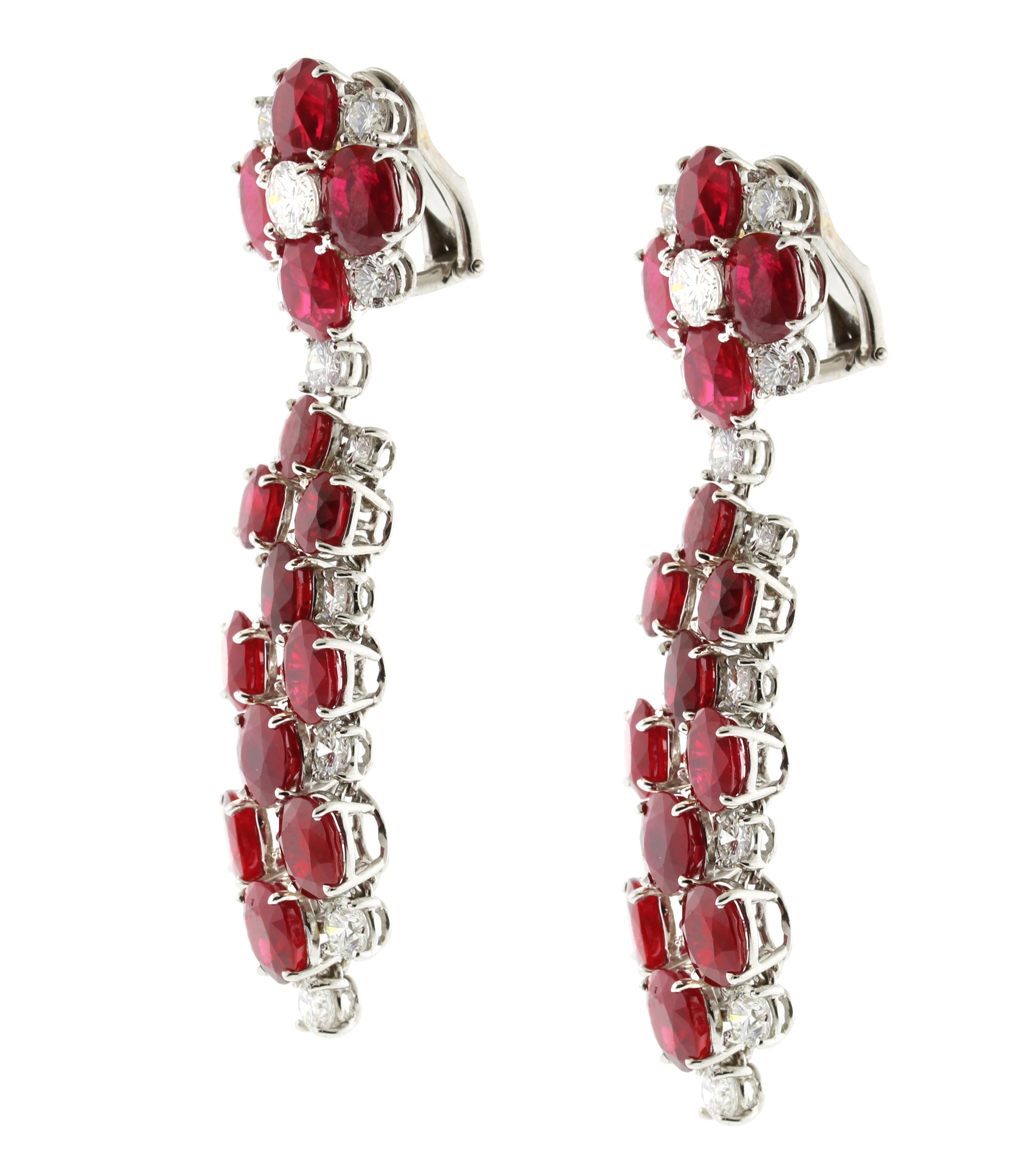 A truly magnificent pair of oval ruby and diamond drop earrings, The earrings are a real show stopper with vivid red rubies and sparkling diamonds. The gems are set in individual settings allowing maximum movement for an uncompromised scintillation.