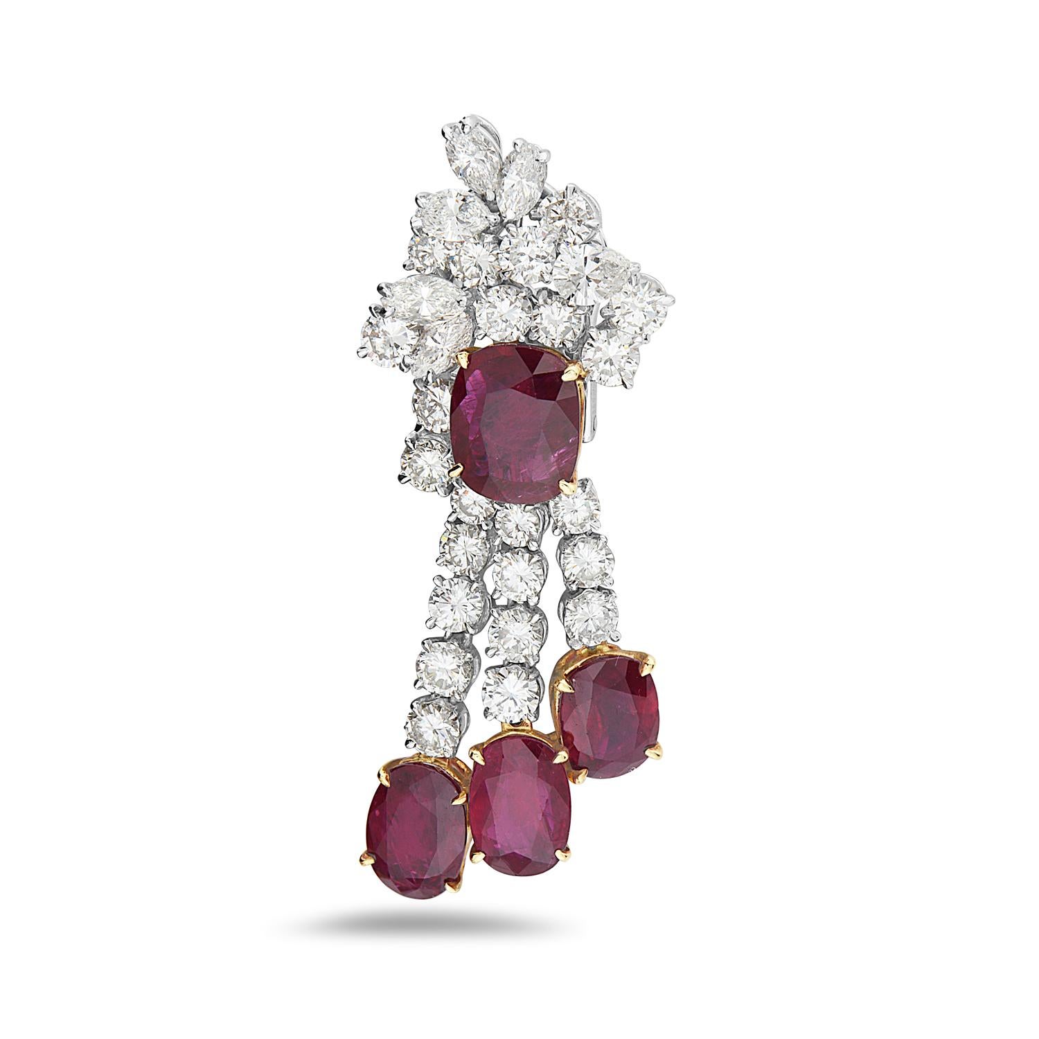 These chandelier earrings feature 18.79 carats of transparent moderately strong red rubies and 8.85 carats of F-H VS-SI pear, marquise, and round cut diamonds. These dazzling earrings feature 2 pear brilliant, 10 marquise brilliant, and 46 round
