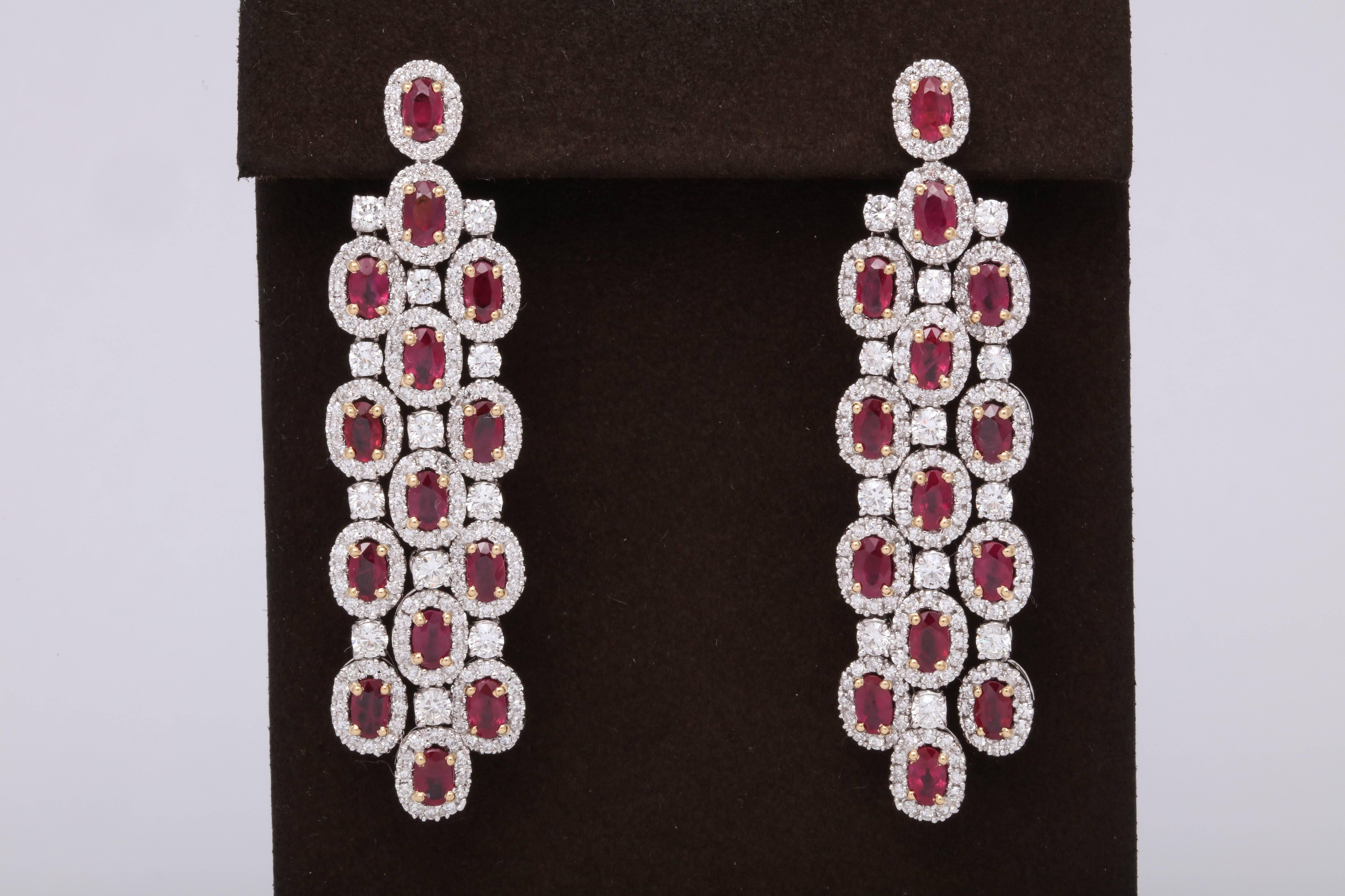 
Elegant ruby and diamond chandelier earrings.

8.55 carats of vivid red oval ruby

4.90 carats of white round brilliant cut diamonds

18k white gold

Approximately 2.38 inches in length, 0.70 inches wide. 