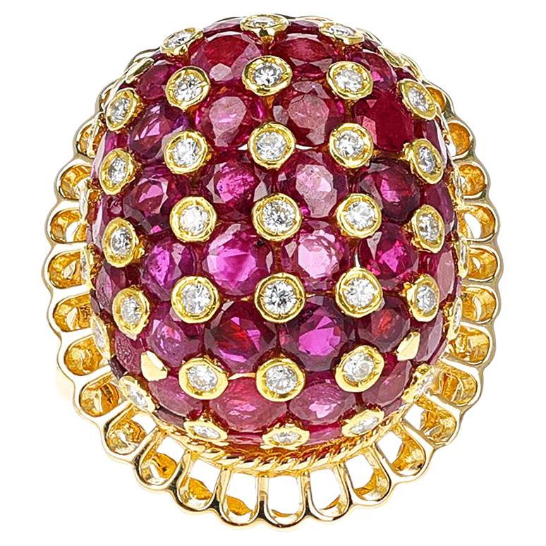 A bold and beautiful Ruby and Diamond Cluster Dome Cocktail Ring made in 18 Karat Yellow Gold. The ring size is US 6. The total weight of the ring is 23.55 grams. 