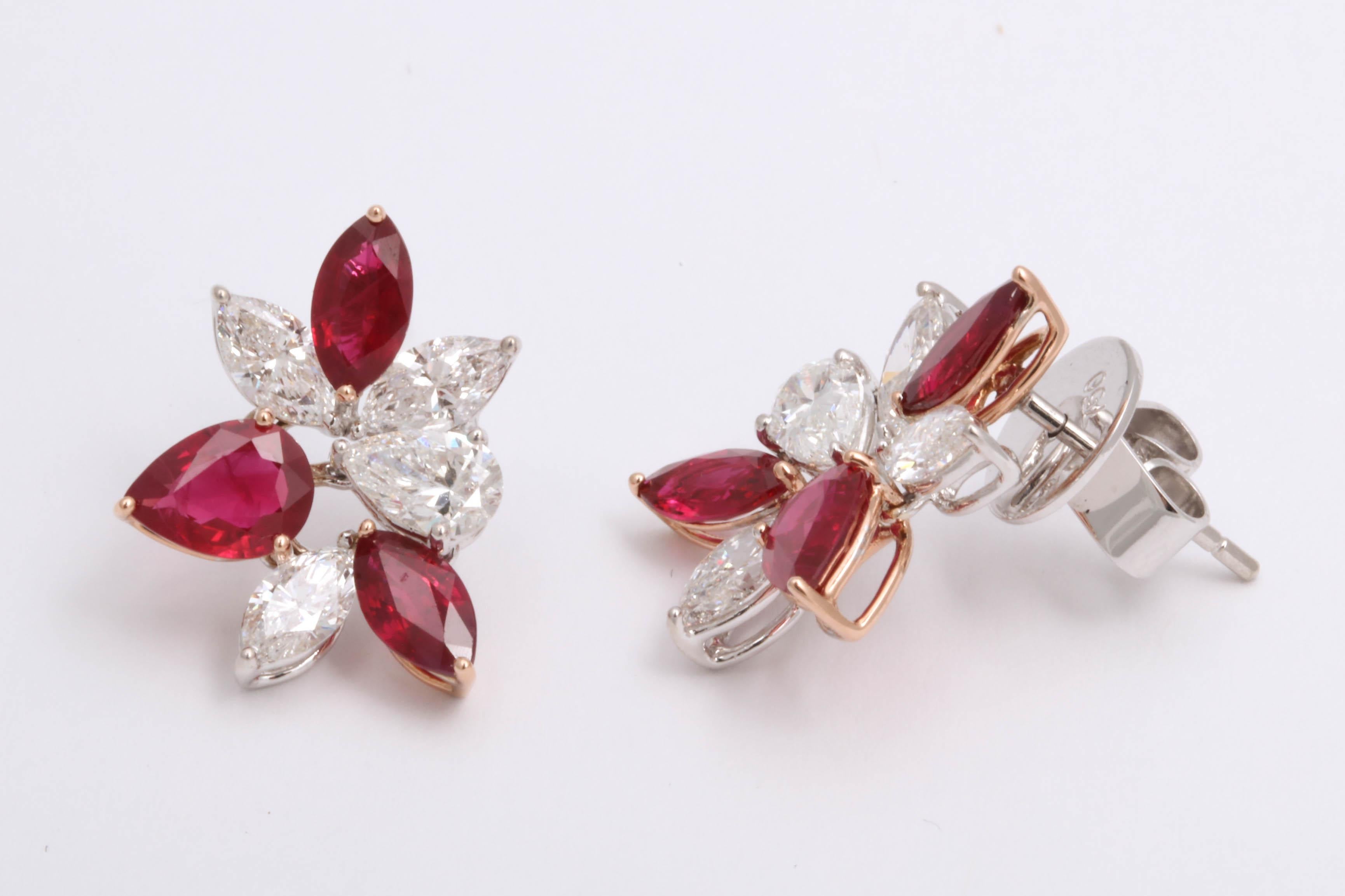 
A beautiful and elegant pair of wearable ruby and diamond earrings.

3.39 carats of pear and marquise shaped fine ruby

2.51 carats of white marquis and pear shaped diamonds 

18k yellow and white gold.

Approximately .75 inches from its highest to
