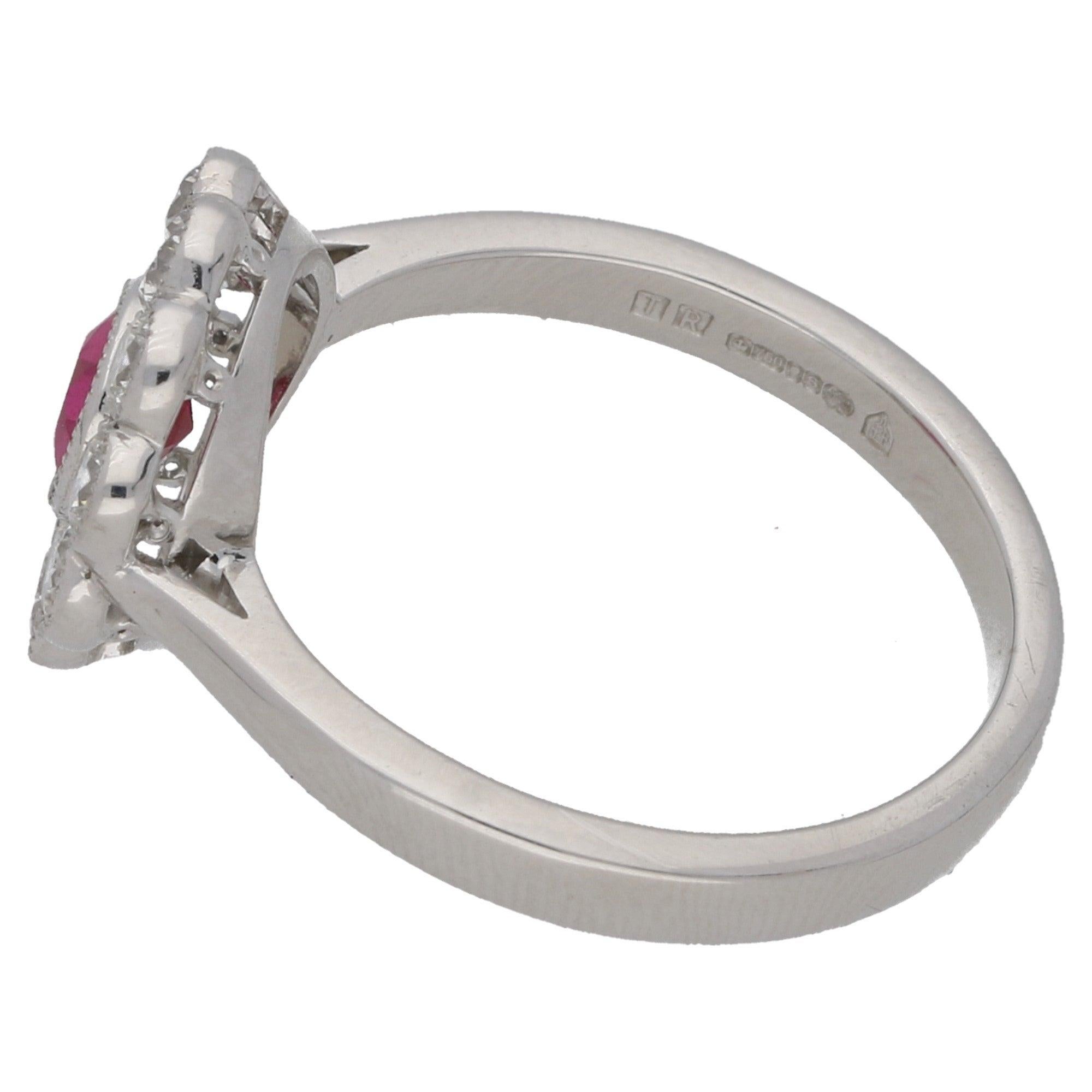An extremely sweet diamond and ruby engagement/cocktail cluster ring set in 18 carat white gold. The ruby is rub over set to centre amongst a halo of ten round brilliant cut diamonds in the same setting.

This is a beautiful piece that could be worn