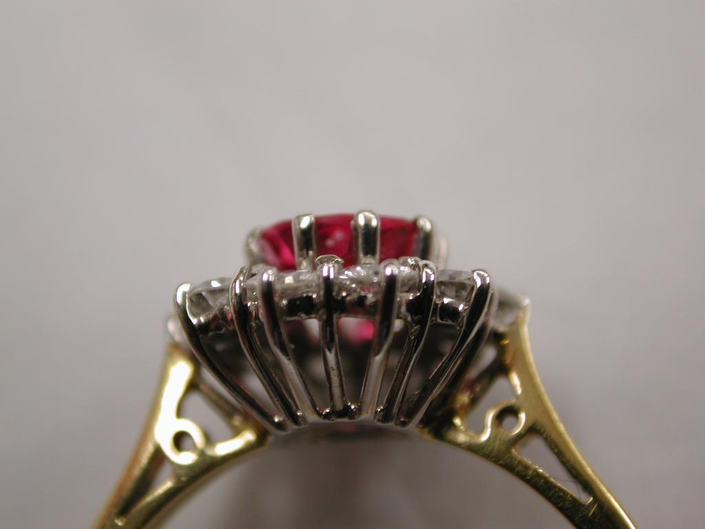 Women's Ruby and Diamond Cluster Ring Set in 18 Carat, Dated 1990, London Assay For Sale