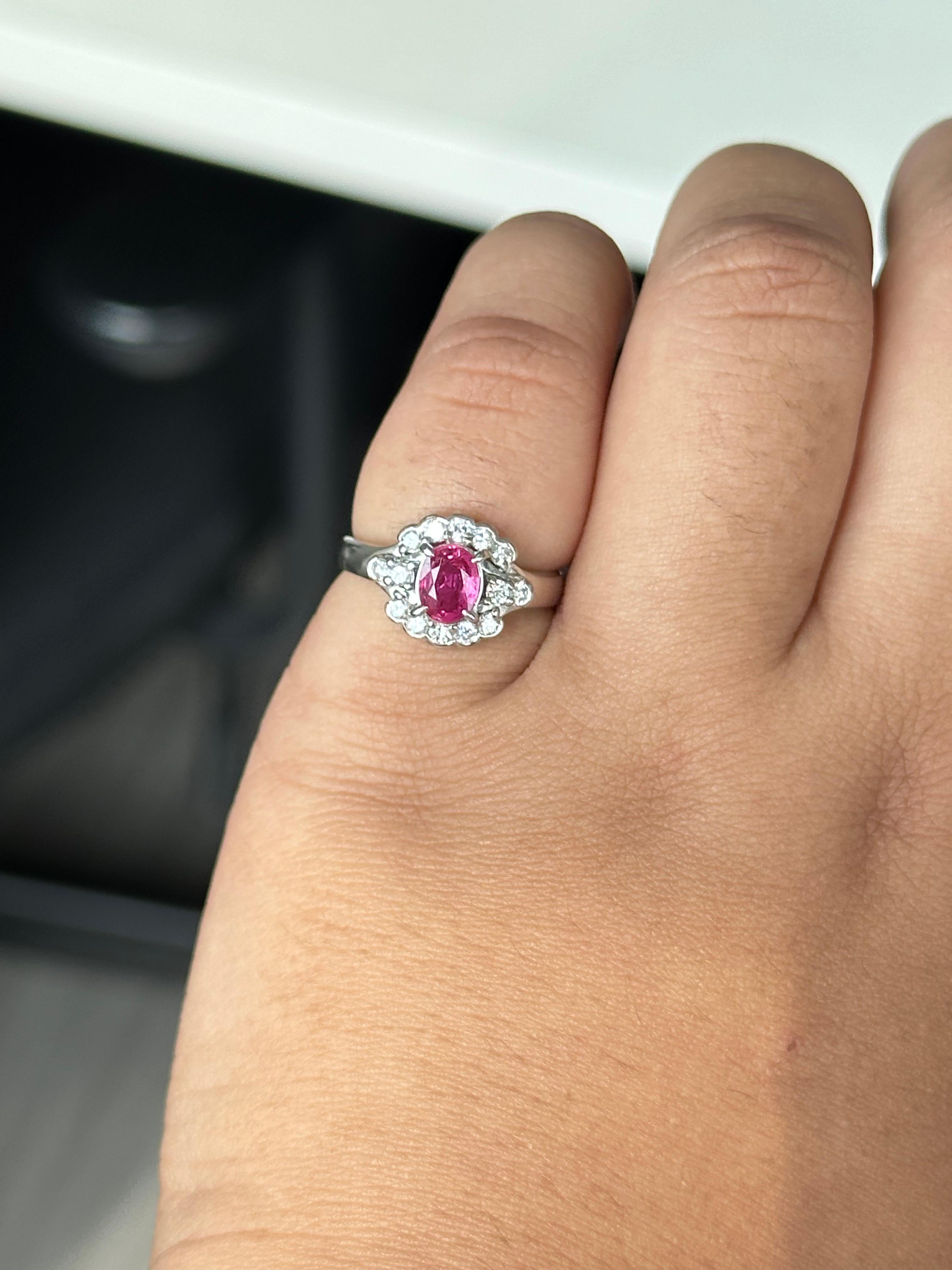 Délicate mais radieuse, cette bague à halo est ornée d'un rubis de 0,72 carat en son centre, d'une riche couleur rouge et d'un charme intemporel. Le rubis est entouré d'un halo de diamants étincelants, tandis que 0,32 carats de diamants naturels