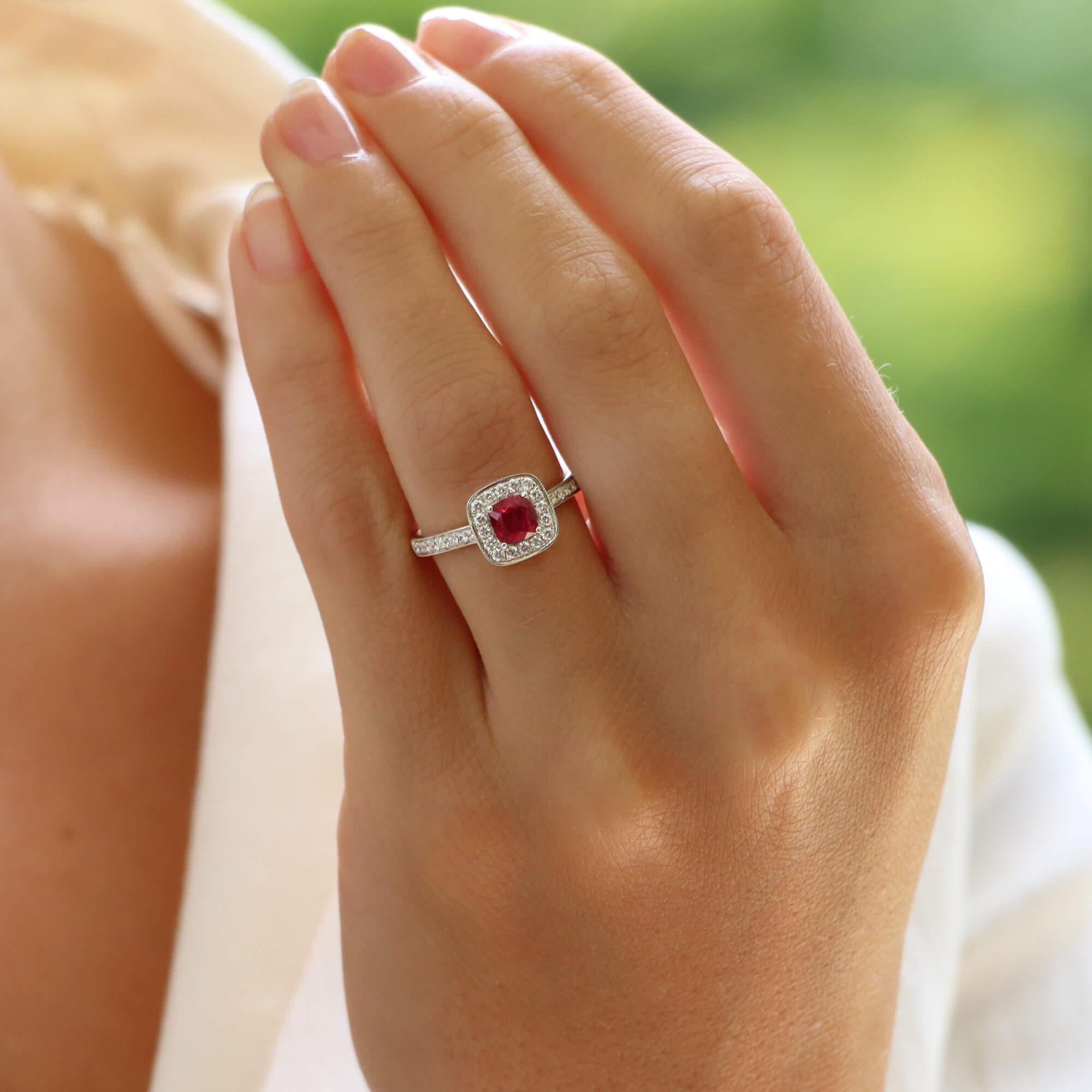 A beautiful ruby and diamond cluster ring set in 18k white gold.

The ring is predominantly set with a vibrant cushion cut red ruby which is four claw set to centre. Surrounding the ruby is then a cluster of 16 sparkly round brilliant cut diamonds,
