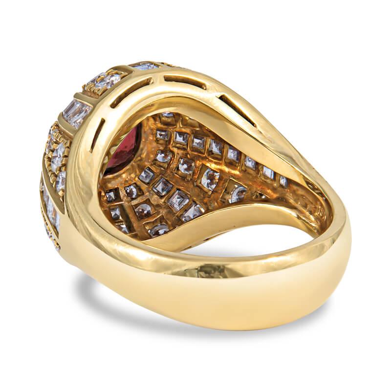 Lady's handmade Bulgari style dome ring in 18KT yellow gold featuring an oval cut ruby weighing 0.98 carats surrounded by channel-set baguette diamonds and round full cut white diamonds for a total weight of 1.90 carats.. 
