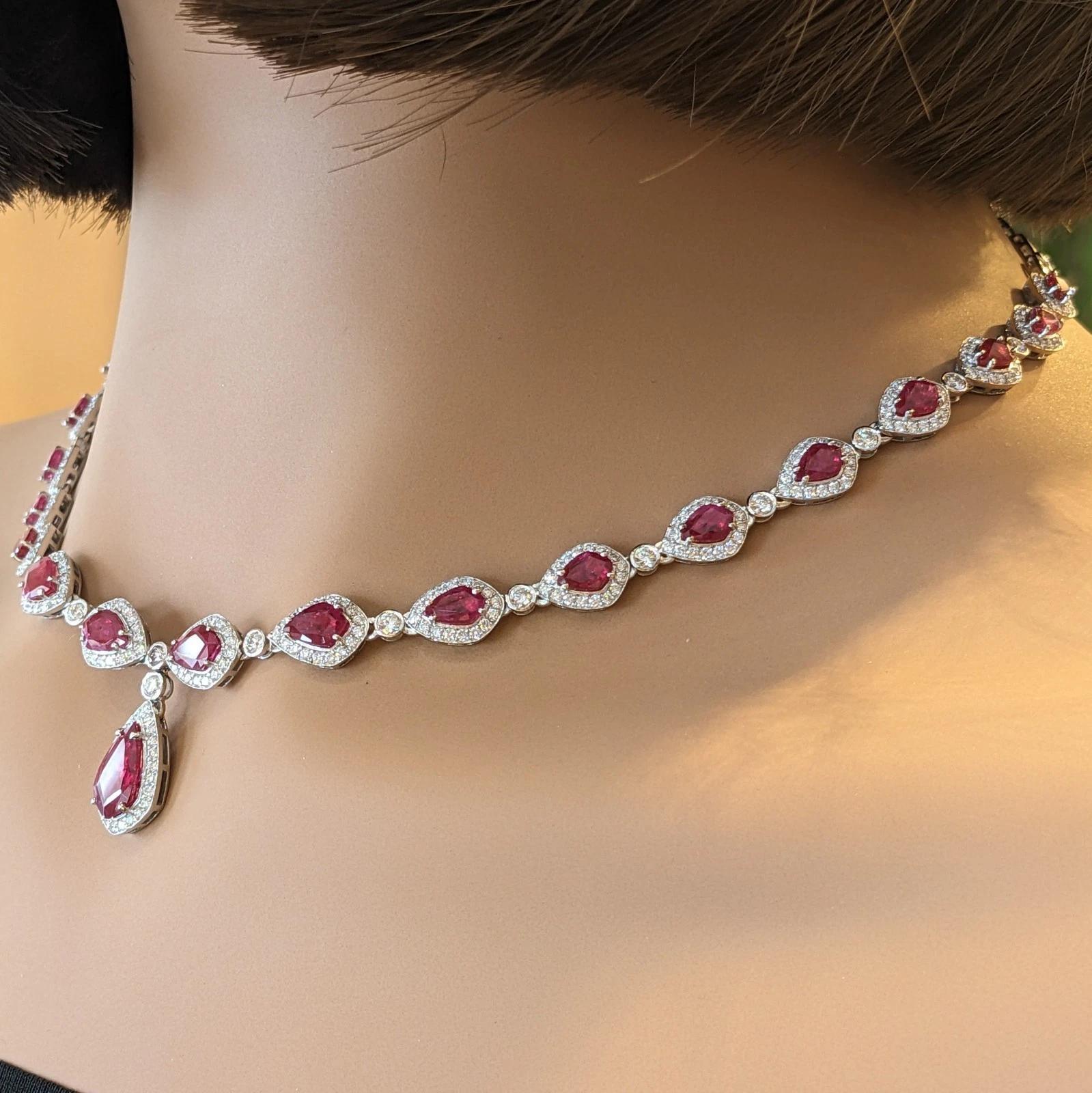 Ruby and Diamond Drop Choker Necklace in 18k White Gold

Ruby and Diamond Necklace features 21 Shield-shaped Natural Rubies, weighing 12.30 carats, set individually and surrounded by Round Brilliant Diamonds, all set in 18k White Gold. The rubies