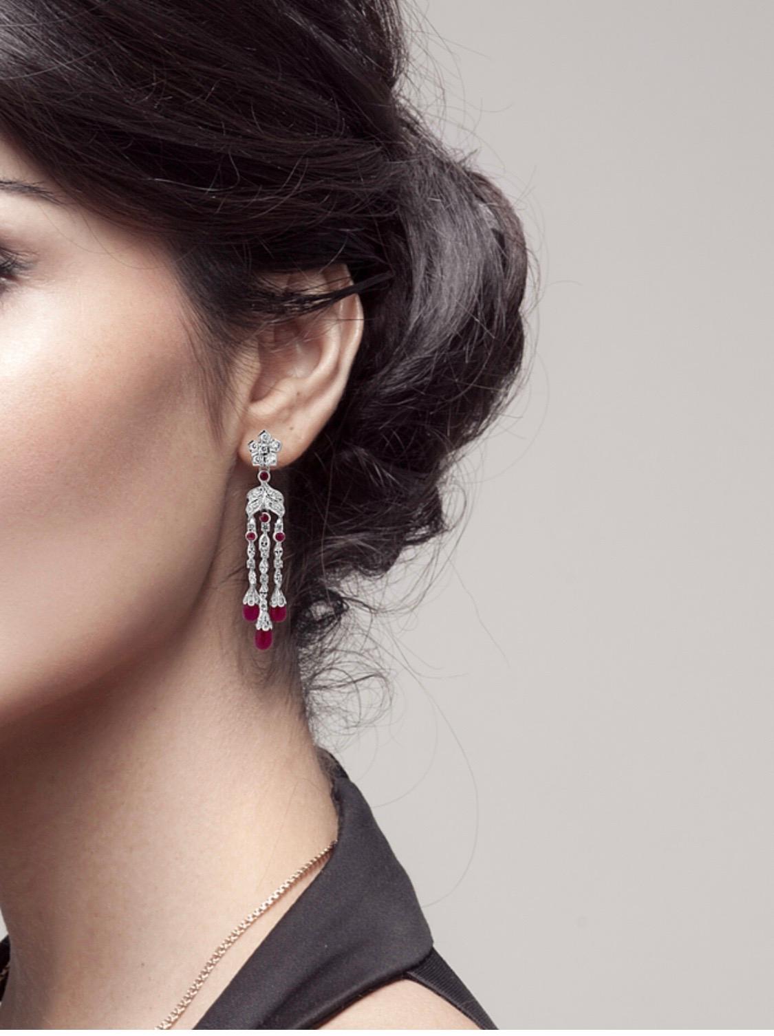 The Jacqueline 
An art deco inspired natural ruby earring, the Jacqueline features 27 carats of natural Burmese rubies with 5 carats of diamonds, and is set in 18K white gold.

Natural Ruby
Shape 	Cabochon Drop 
Color	Red
Clarity 	Fine 
Treatment,