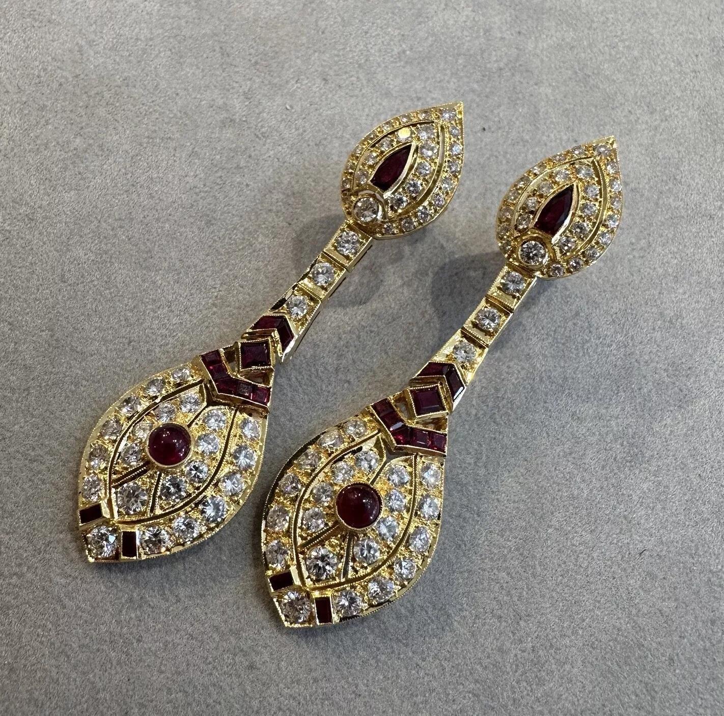 Ruby and Diamond Drop Earrings in 18k Yellow Gold 

Diamond and Ruby Dangle Earrings feature Round Brilliant cut Diamonds accented with Deep Red Rubies, all set in 18k Yellow Gold.

Total diamond weight is 6.67 carats.

Earrings measure 2.35 inches