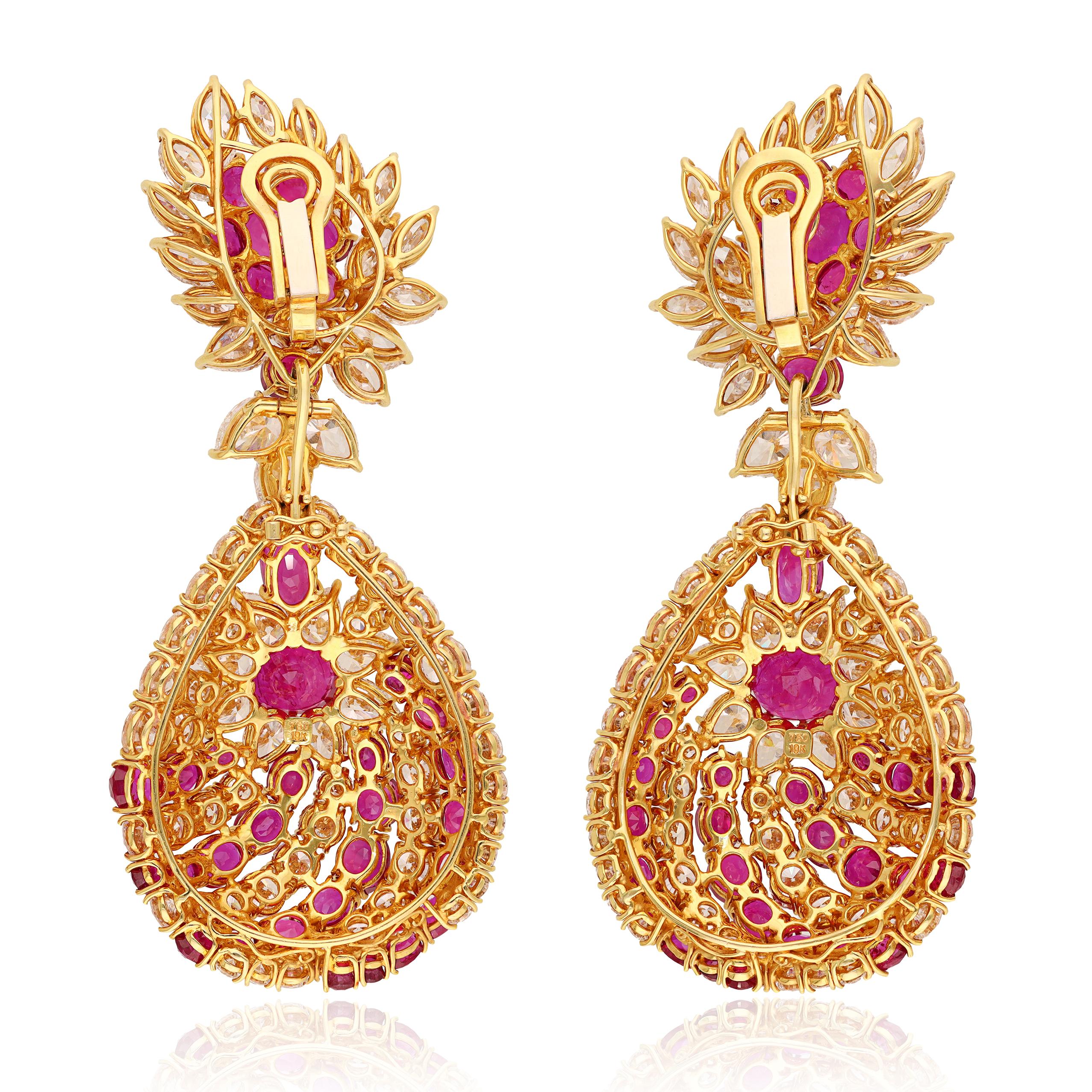 These exquisite statement earrings feature a stunning combination of marquise and brilliant-cut diamonds alongside oval and brilliant-cut rubies, all meticulously handset in luxurious 18K yellow gold. The design showcases not only the brilliant