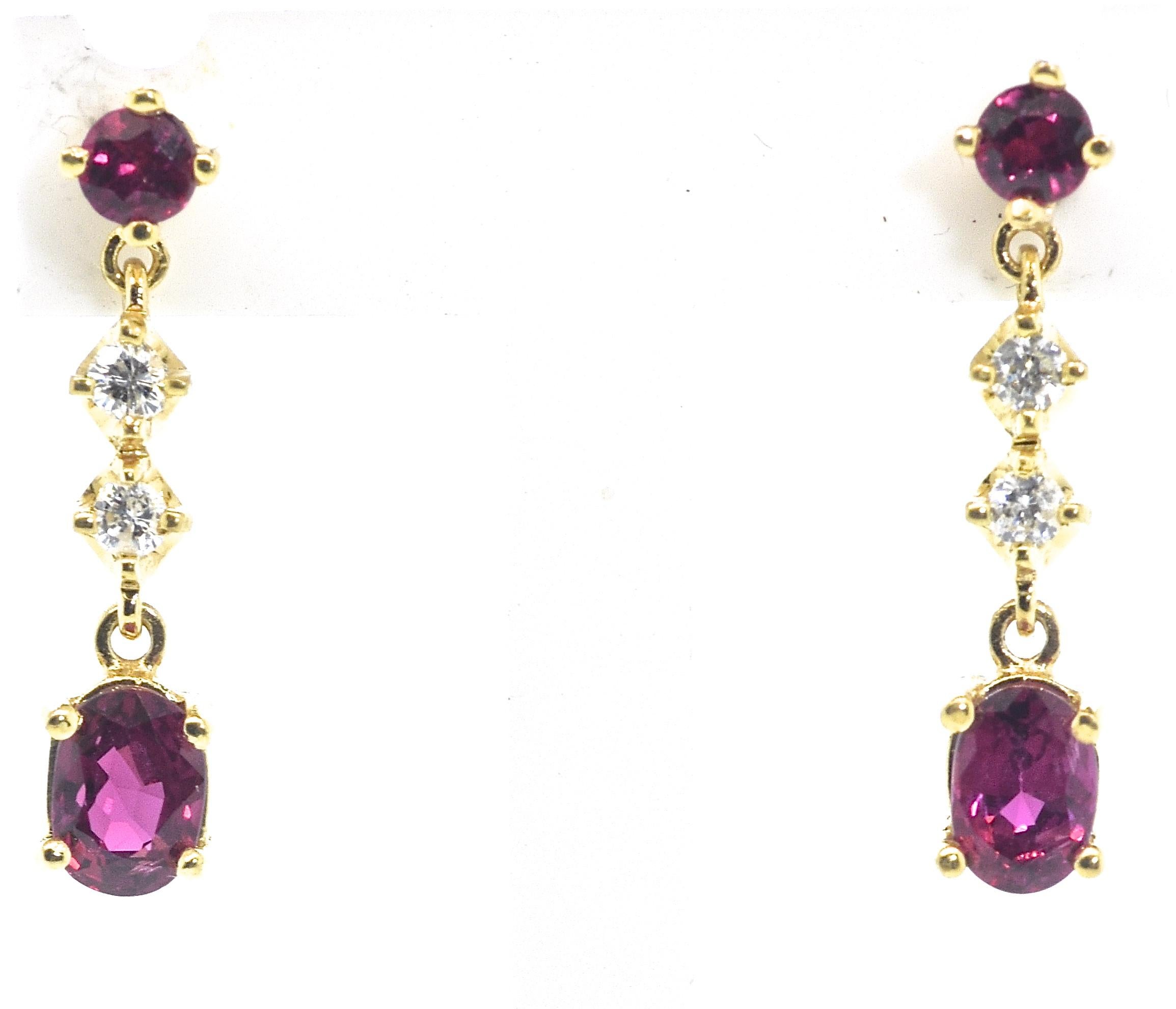 Diamond and ruby dangling earrings.  The rubies are natural, vibrant red and clean.  The oval cut, prong set suspended rubies at the bottom weigh an estimated .45 cts. each and the tops weigh .13 cts., each with a total estimated weight of natural