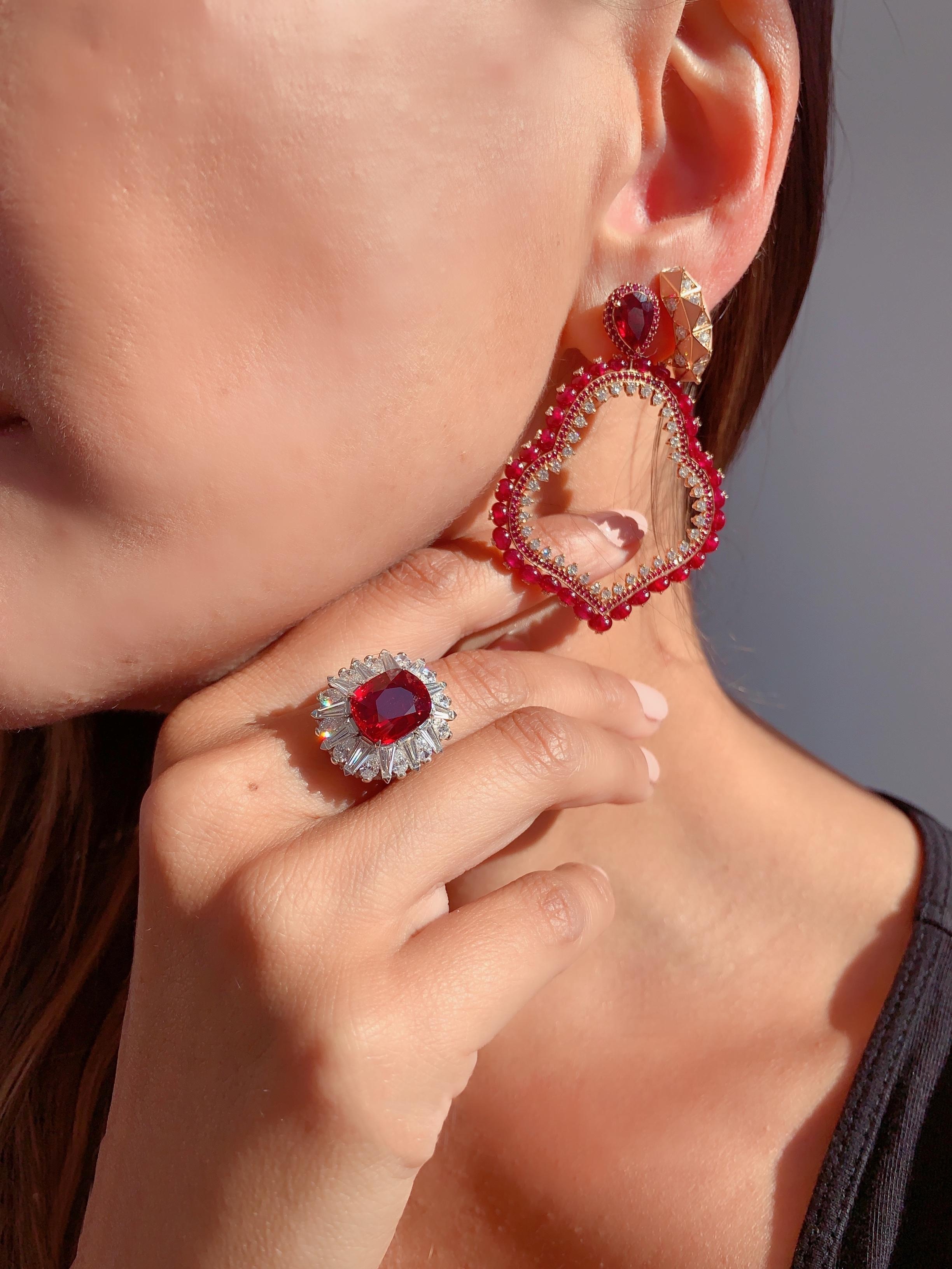 A Pair of Ruby and Diamond Gold Earrings by Jewelry Designer, Sarah Ho.

These Ruby earrings have pear cut rubies 'reimagined' from an old piece, at 1.67ct each. They are set in 18kt rose gold with an additional 26.68ct of rubies and 2.01ct