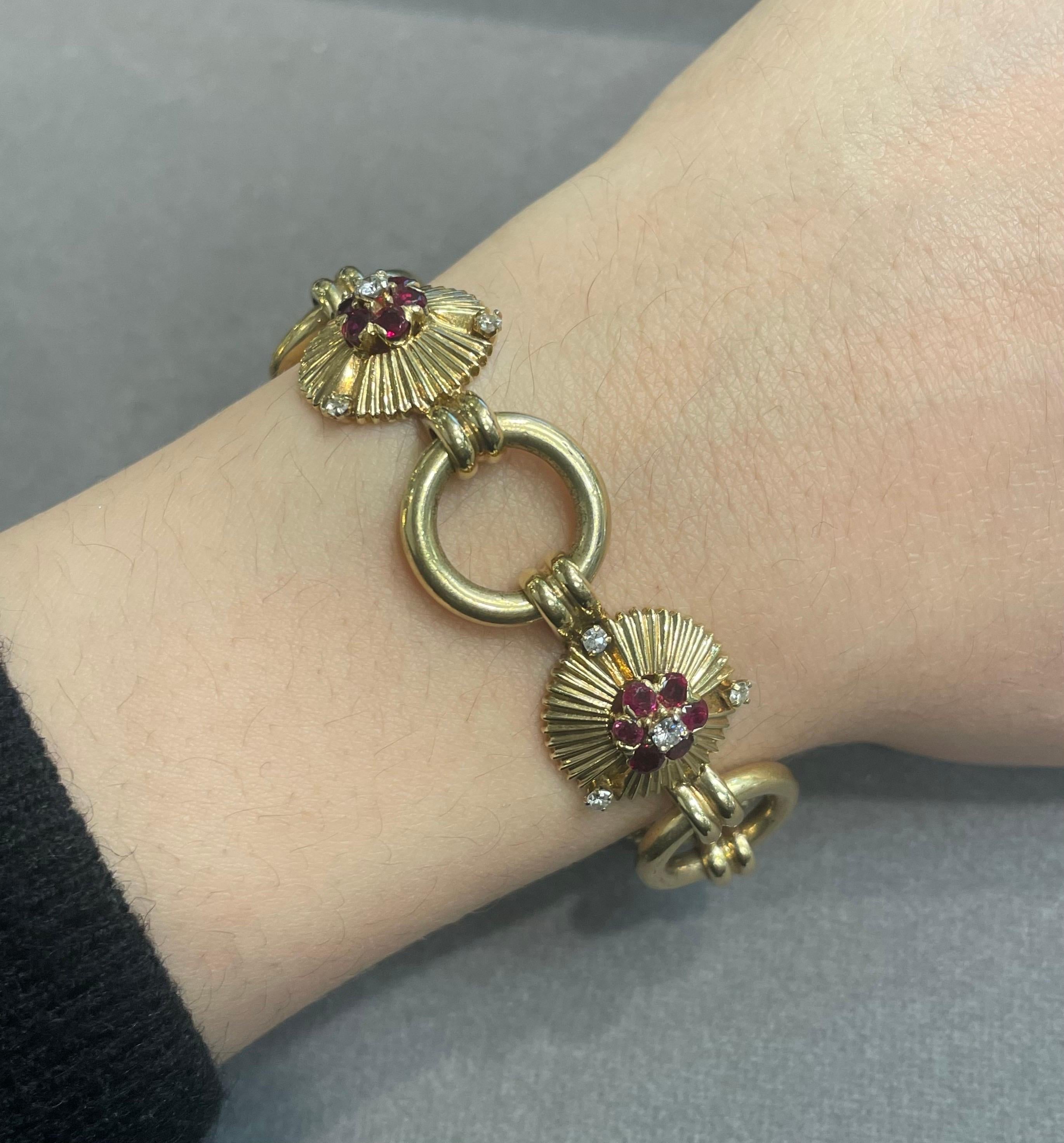Ruby and Diamond Floral Motif Bracelet 

A gold link bracelet with 5 floral motifs made from round cut diamonds and rubies. 

Approximate Diamond Weight: .85 carats
Approximate Ruby Weight: 2.50 carats

Approximate Length:  7.75