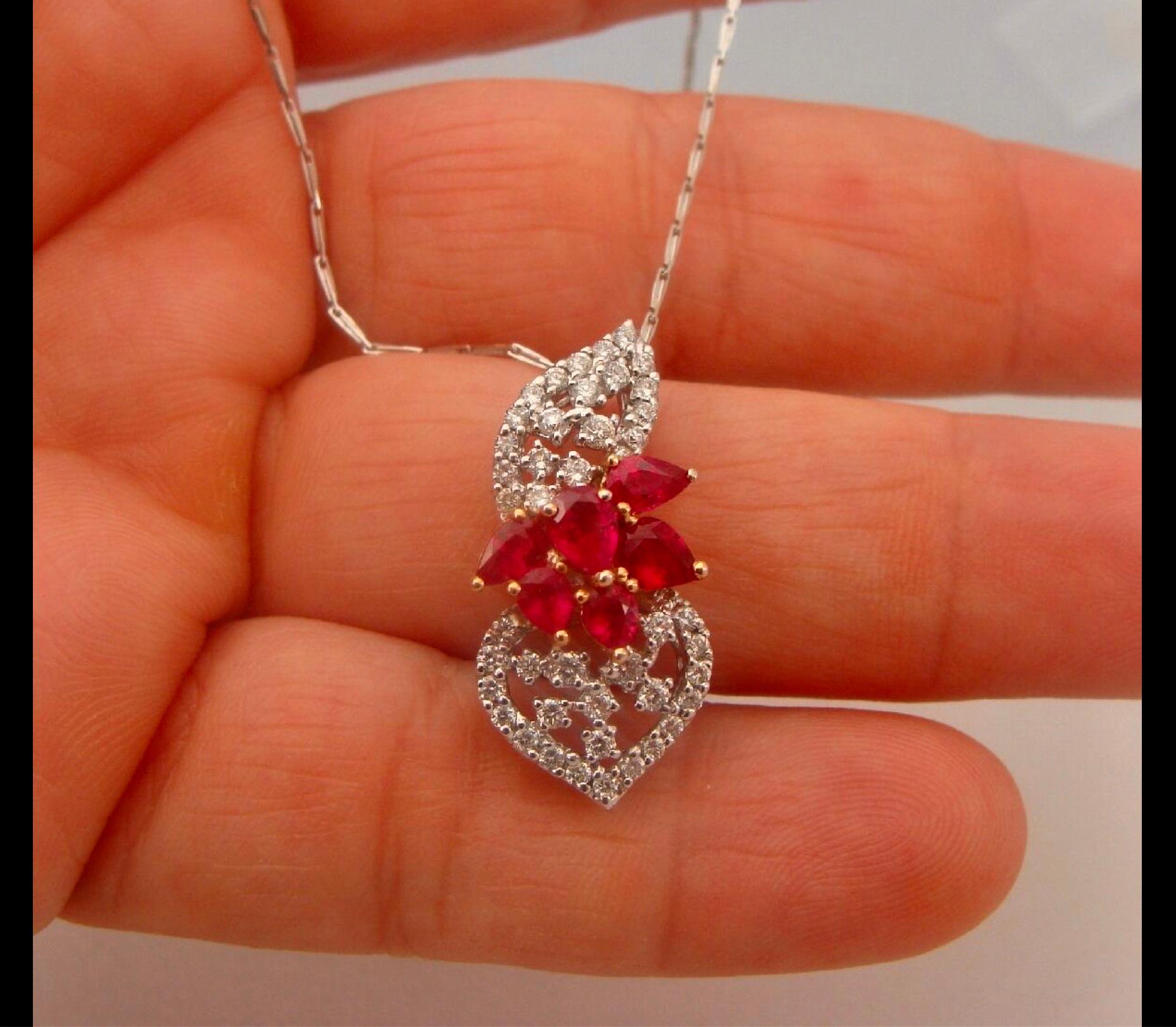 Beautiful design ruby diamond floral pendant in 18K white and yellow gold
The Pendant is centered with 6 genuine pear cut rubies approx. 2.50 carat and adorned with 45 natural diamonds approx. 1.50 carat. Color and clarity J-SI2/SI3 .
Total Weight 