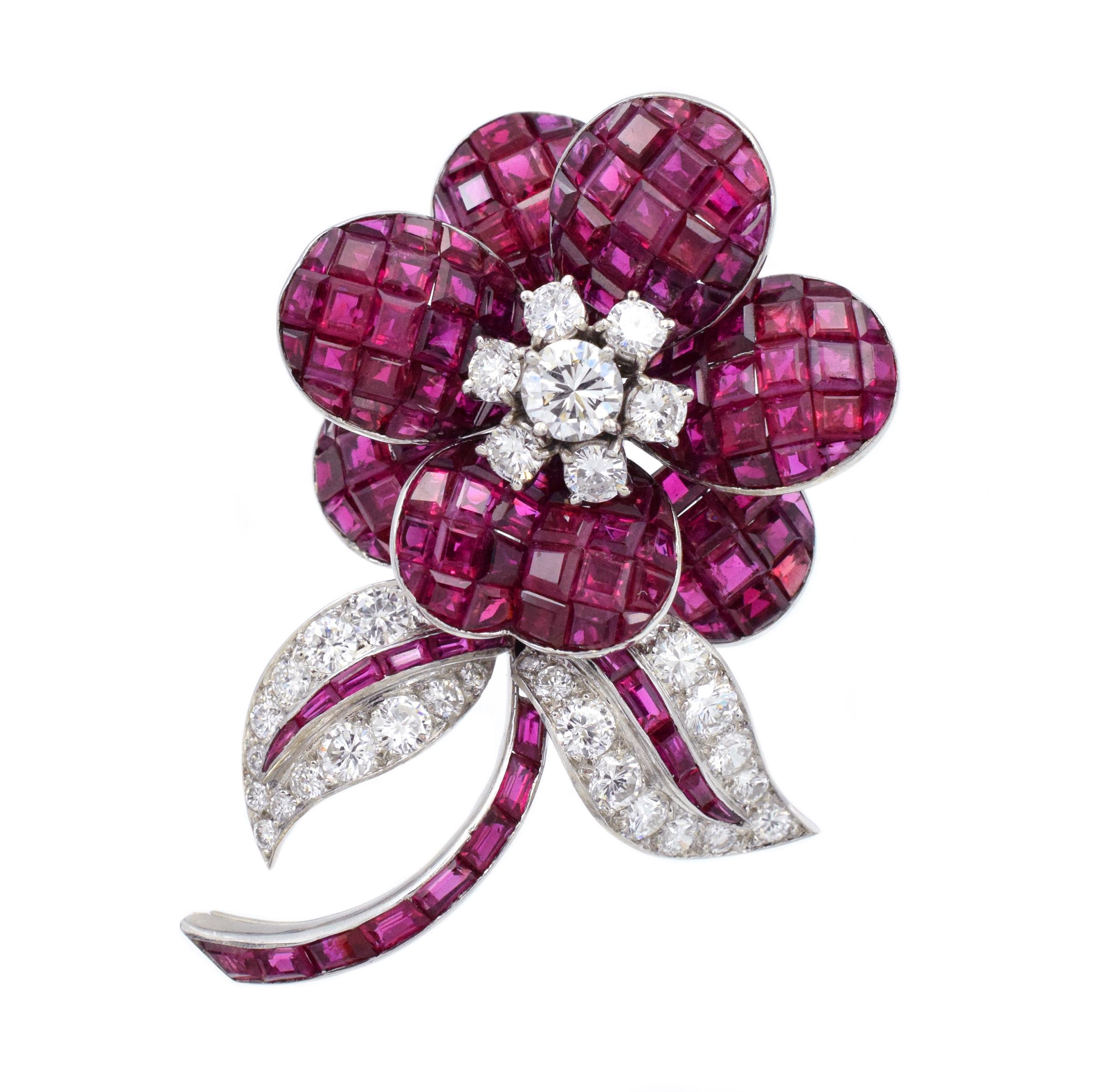 Ruby and Diamond Flower Brooch This brooch has invisibly set ruby petals and round brilliant-cut
diamond pistils, extending to a calibré cut ruby stem with further ruby and diamond leaves; with
French maker's mark and assay marks; estimated total