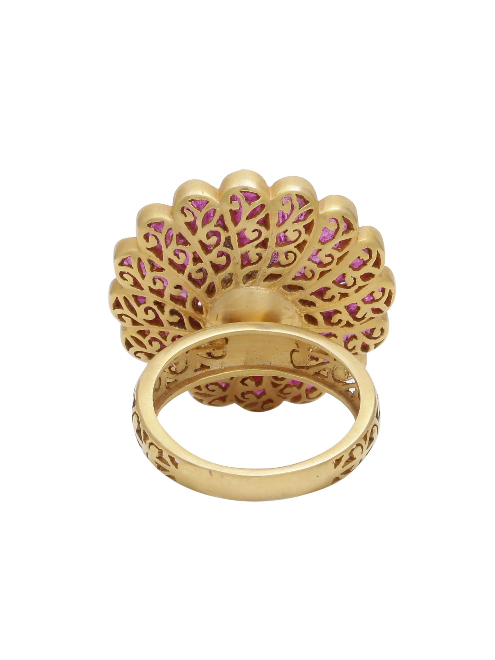 A handcrafted Ruby ring with a Rosecut diamond in the centre made in 18K Yellow Gold.
The band and the back of the ring you will notice intricate hand work done on gold that compliments the beautiful top.
The Rubies are customised and  hand cut to