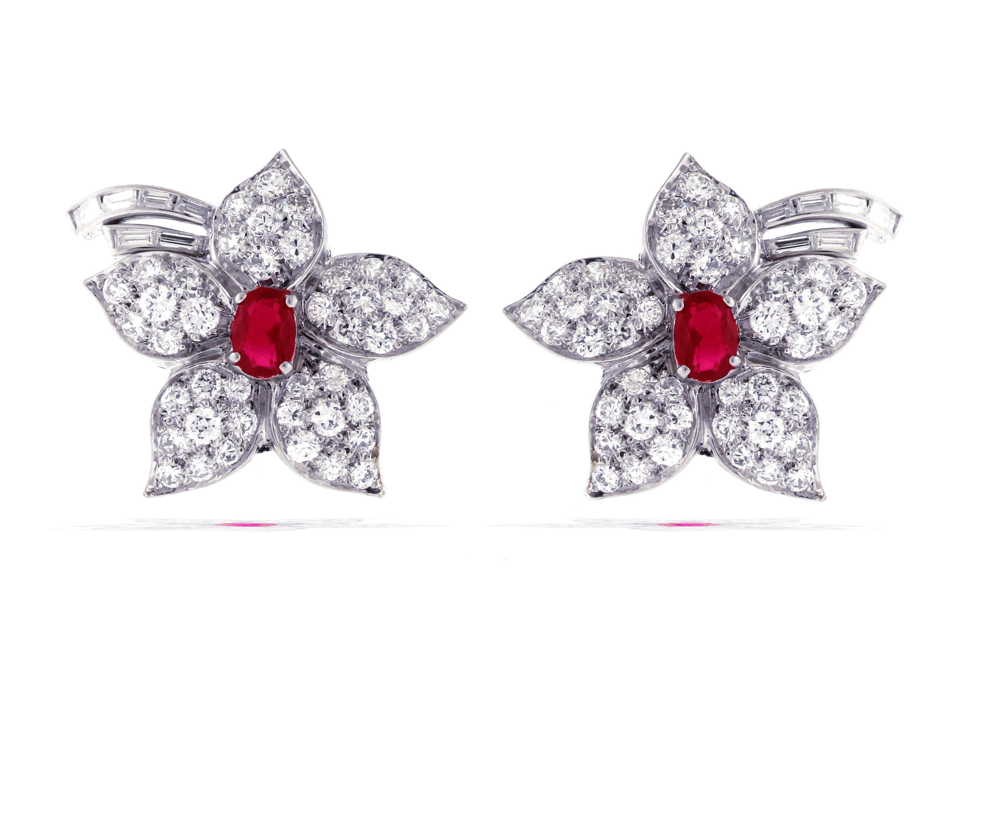 A stunning pair of oval ruby and diamond flower earrings.
• Metal: Platinum
• Circa: 1970s
• Size 7/8ths by 1 1/8th of an inch
• Diamond 82 Rounds diamond weigh 3 carats, 12 Baguette diamonds weigh 1.20 carats:
• 2 oval rubies weigh 1.20 carats
•