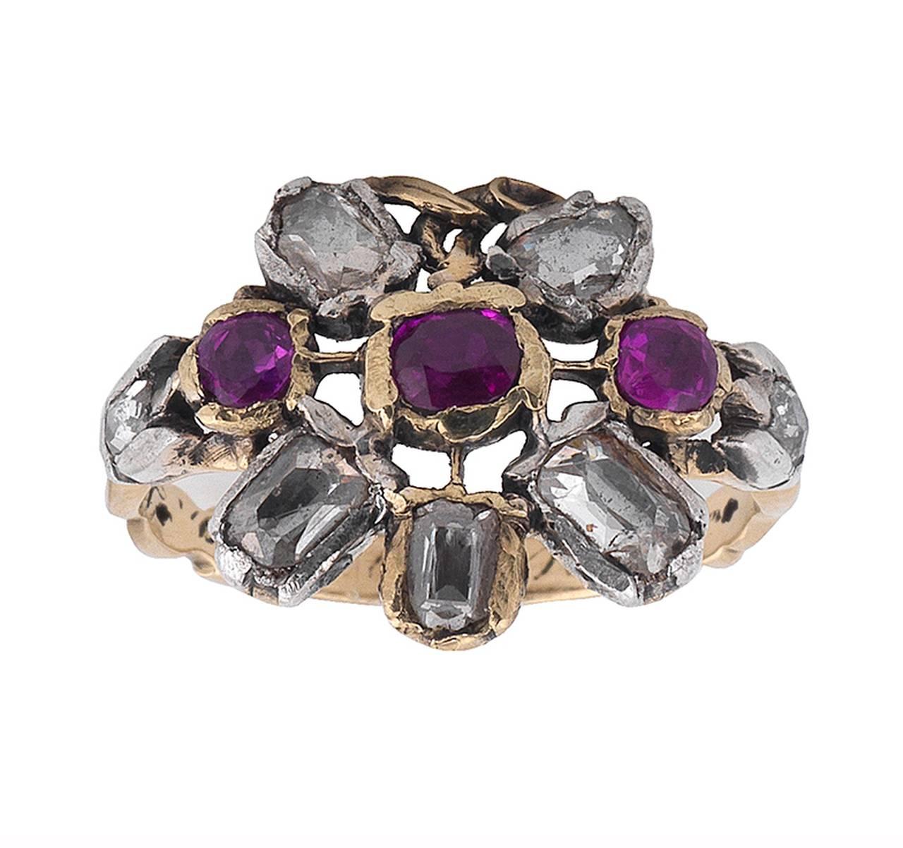 Designed as a basket issuing a floral and foliate spray, set throughout with vari-cut rubies and diamonds, ring size 7