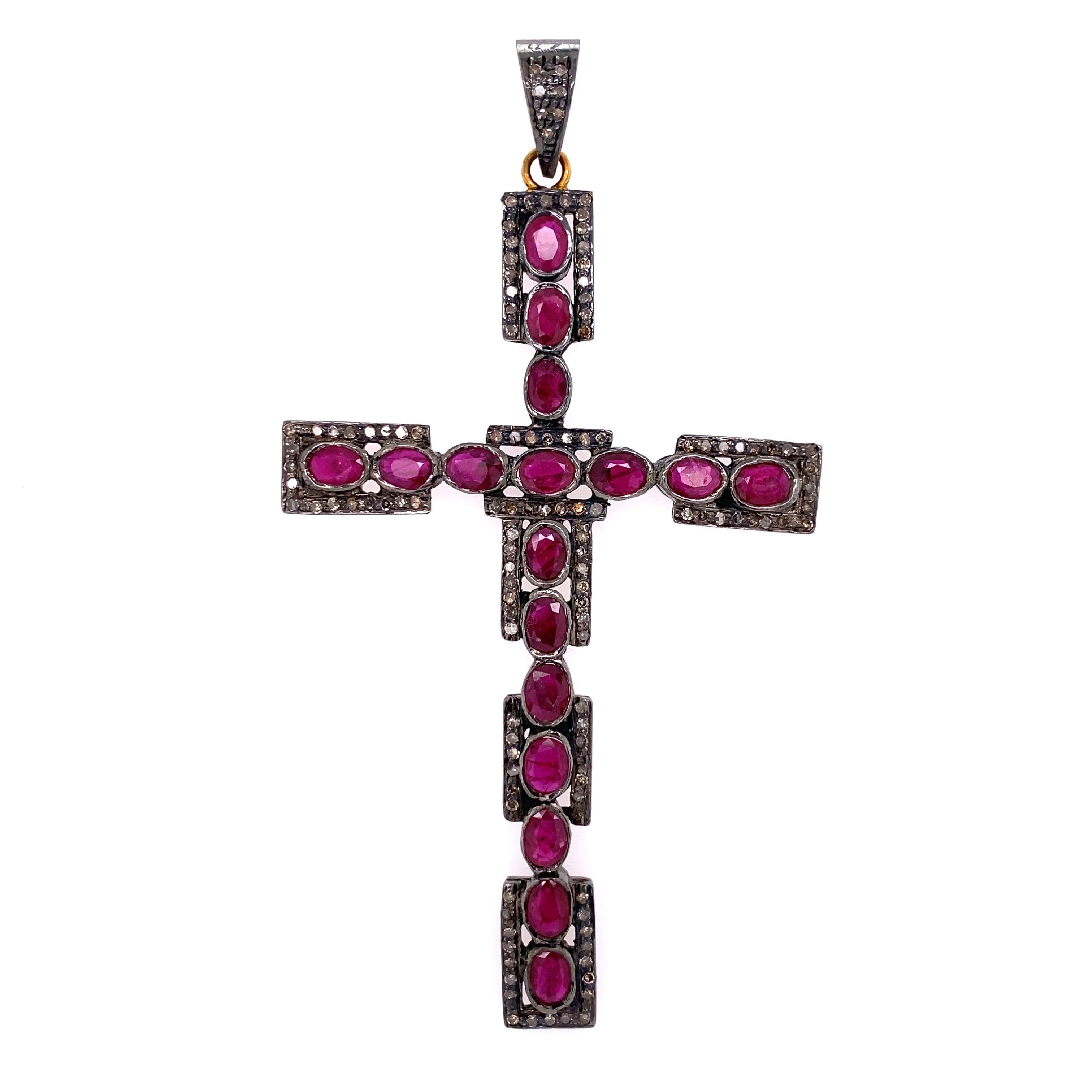 Simply Beautiful! Finely Detailed Ruby and Diamond Cross, Hand set with Rubies, approx. 4.30tcw and Diamonds, weighing approx. 1.02tcw. Hand crafted in 925 Sterling Silver and 14K Yellow Gold. The Cross measures approx. 3.50” tall. A must have