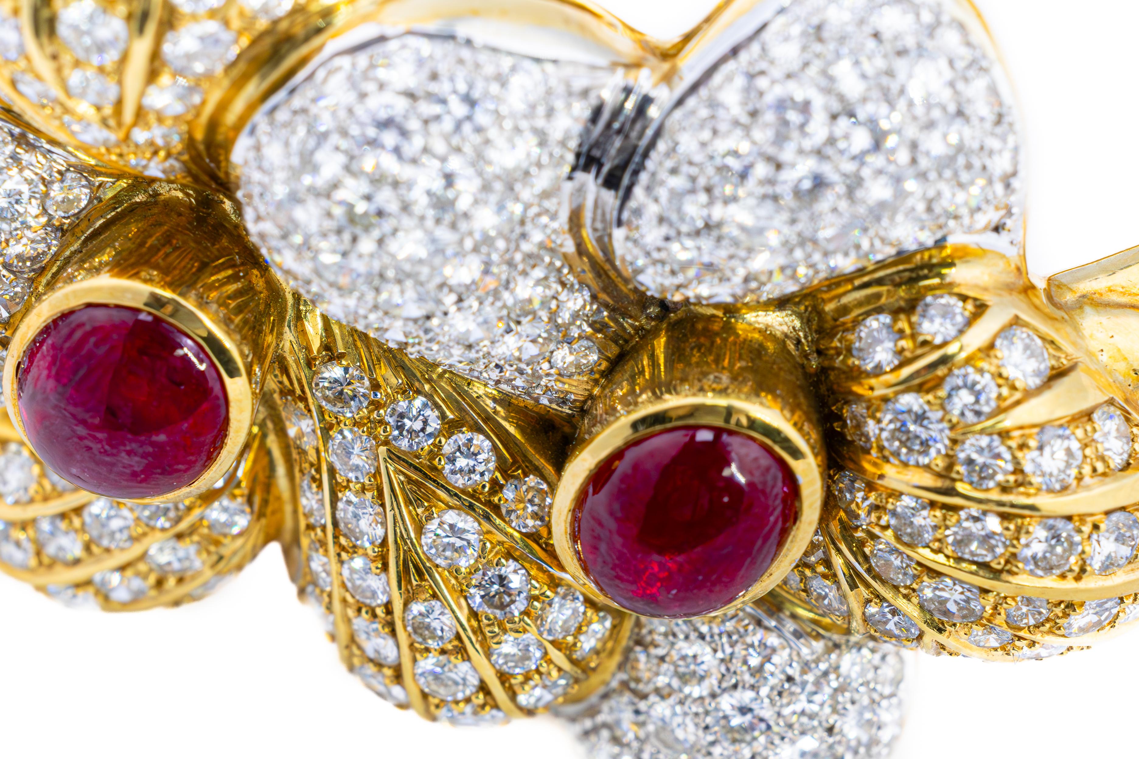 Ruby and Diamond Gold Bangle Bracelet

Description:
A magnificent bangle bracelet, exquisitely crafted in 18K yellow gold, adorned with two captivating cabochon rubies weighing approximately 6.00 carats. The lush red hues of the rubies are