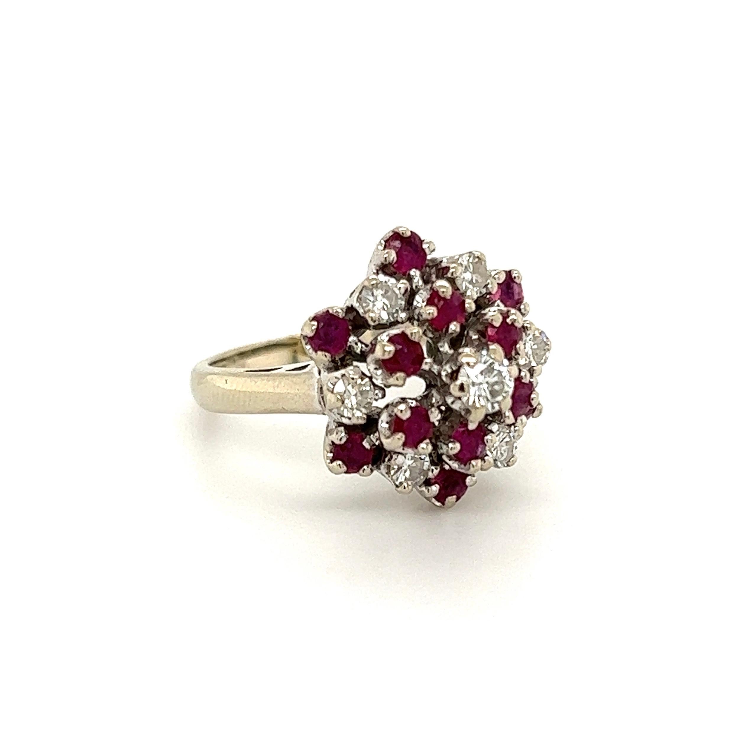 Beautiful Ruby and Diamond Cluster Ring, Hand set with Diamonds weighing approx. 0.48tcw and Rubies, approx. 0.90tcw. The ring is Hand crafted in 14K White Gold. Measuring approx. 1.12”L x 0.73”W x 0.65”H. Ring Size 4.75, we offer ring re-sizing.