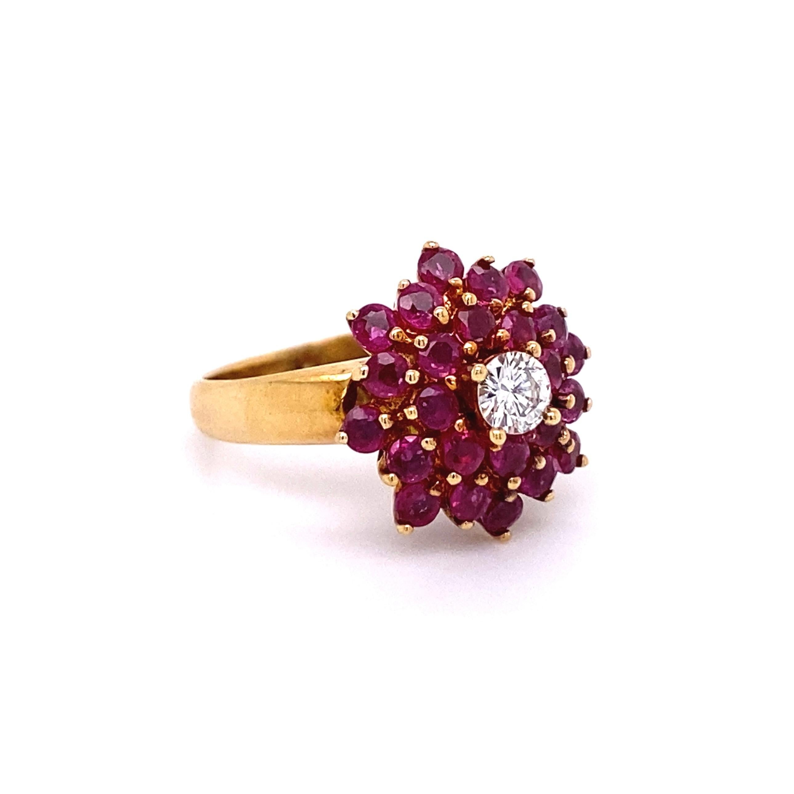 Beautiful Ruby and Diamond Cluster Ring, centering a Diamond weighing approx. 0.17 Carat surrounded by Rubies, approx. 1.36tcw. The ring is Hand crafted in 18K Yellow Gold. Measuring approx. 0.92”L x 0.68”W x 0.55”H. Ring Size 4, we offer ring