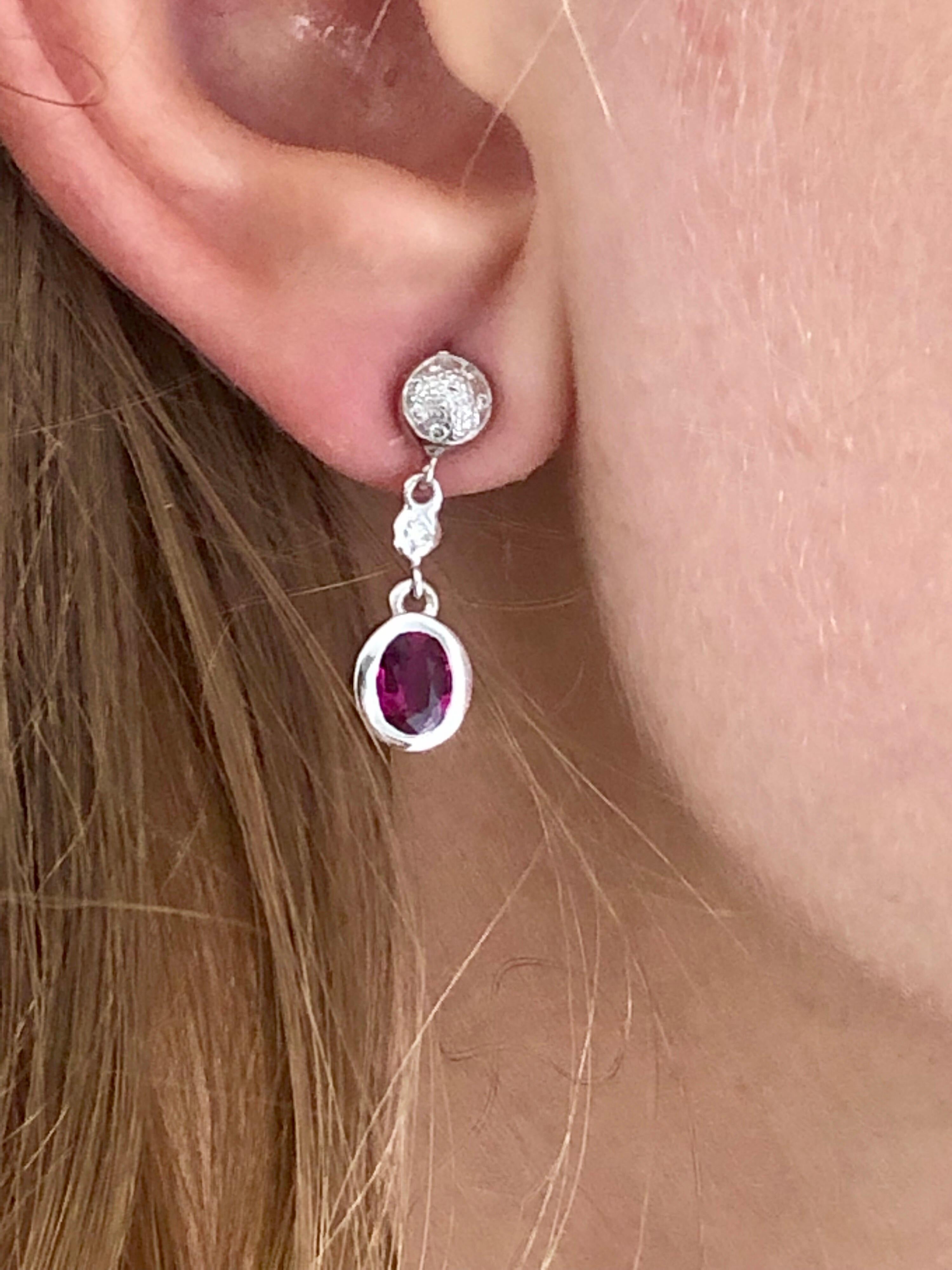 Fourteen karats white gold diamond and ruby earrings measuring 1