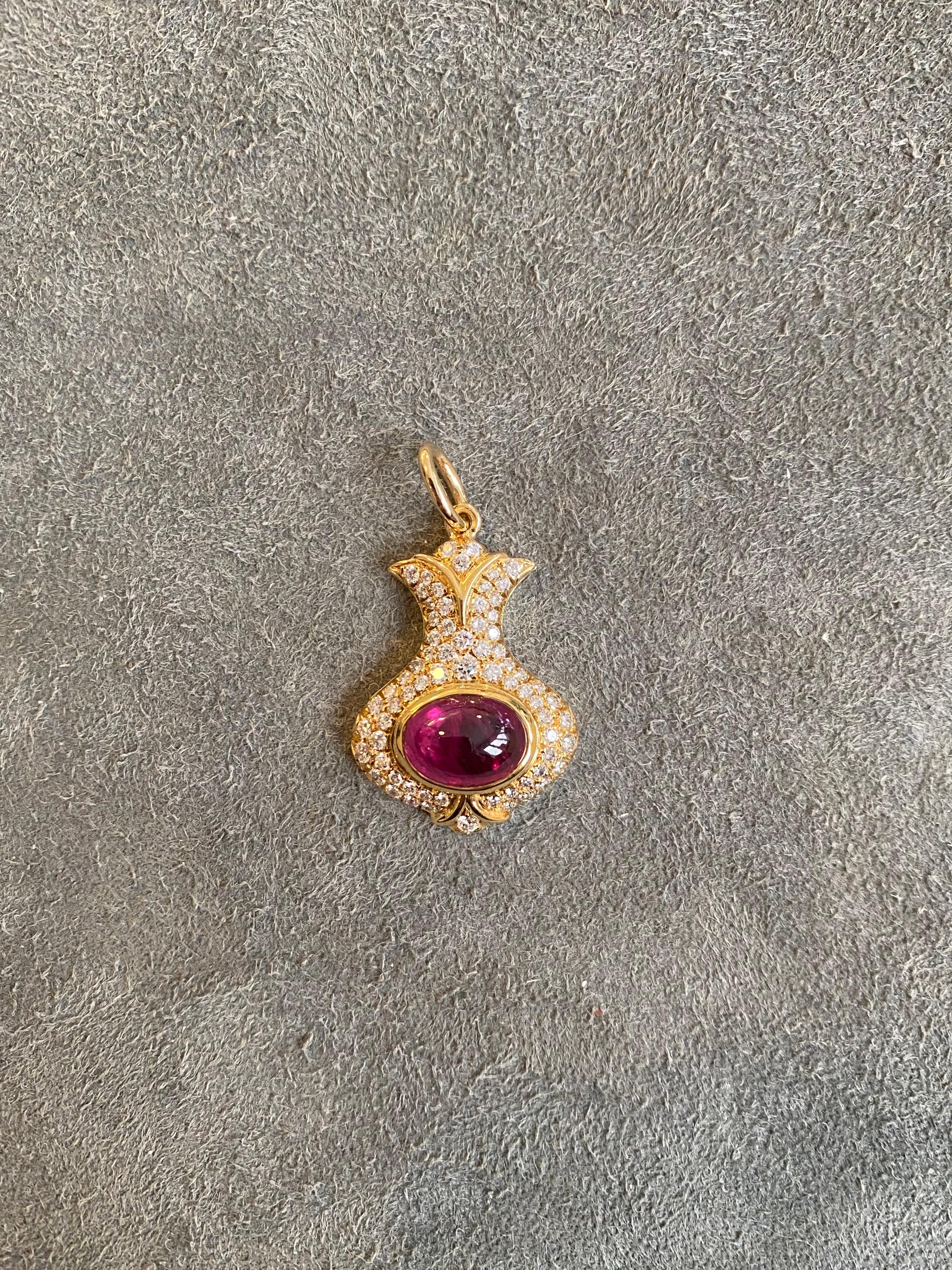 A 18k yellow gold pendant set with a cabochon ruby and approximately 1ct of diamonds (F-G VS). This is a pendant sold without chain. 