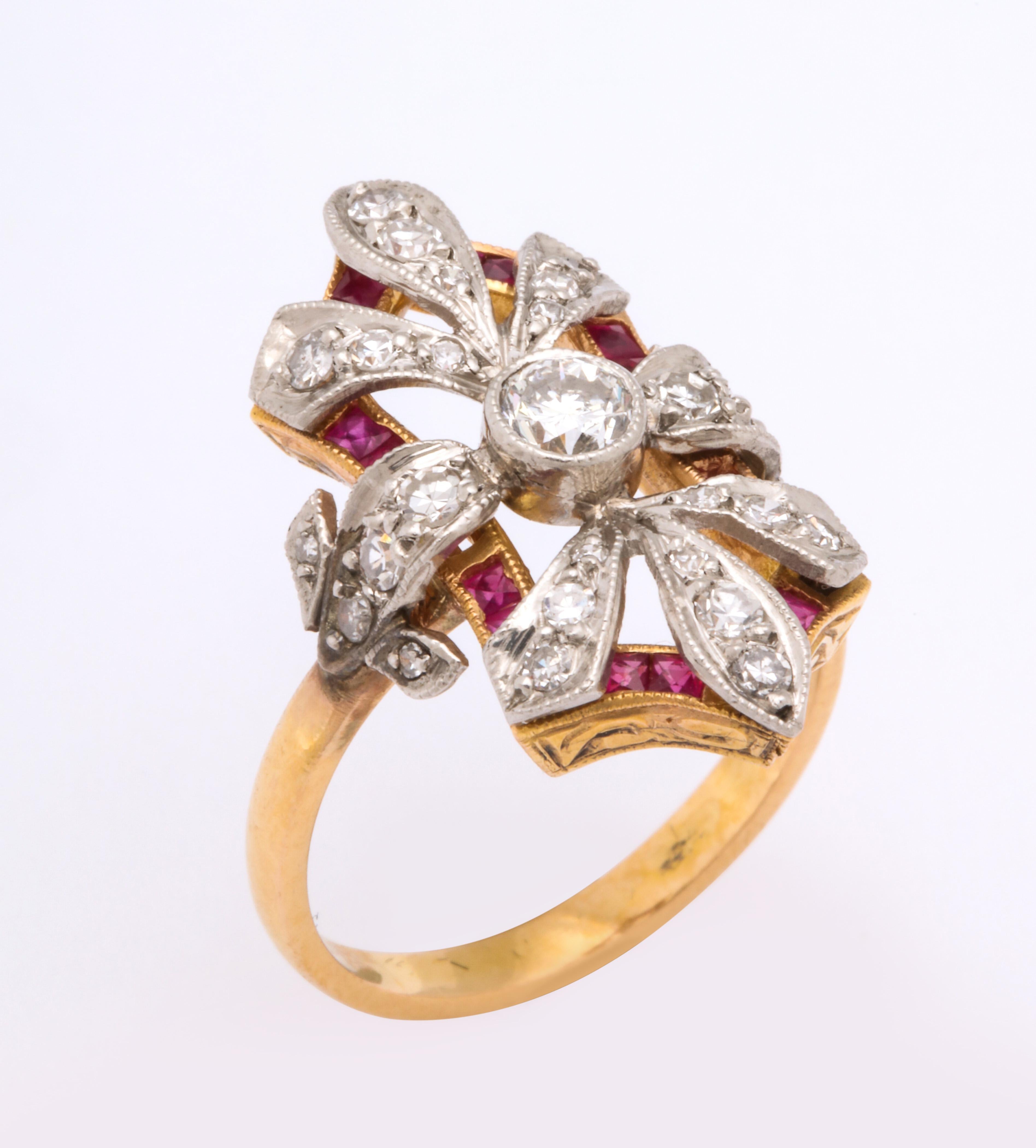 A great floral arrangement of diamonds with a ribbon of rubies supporting a white gold setting over a rose gold body