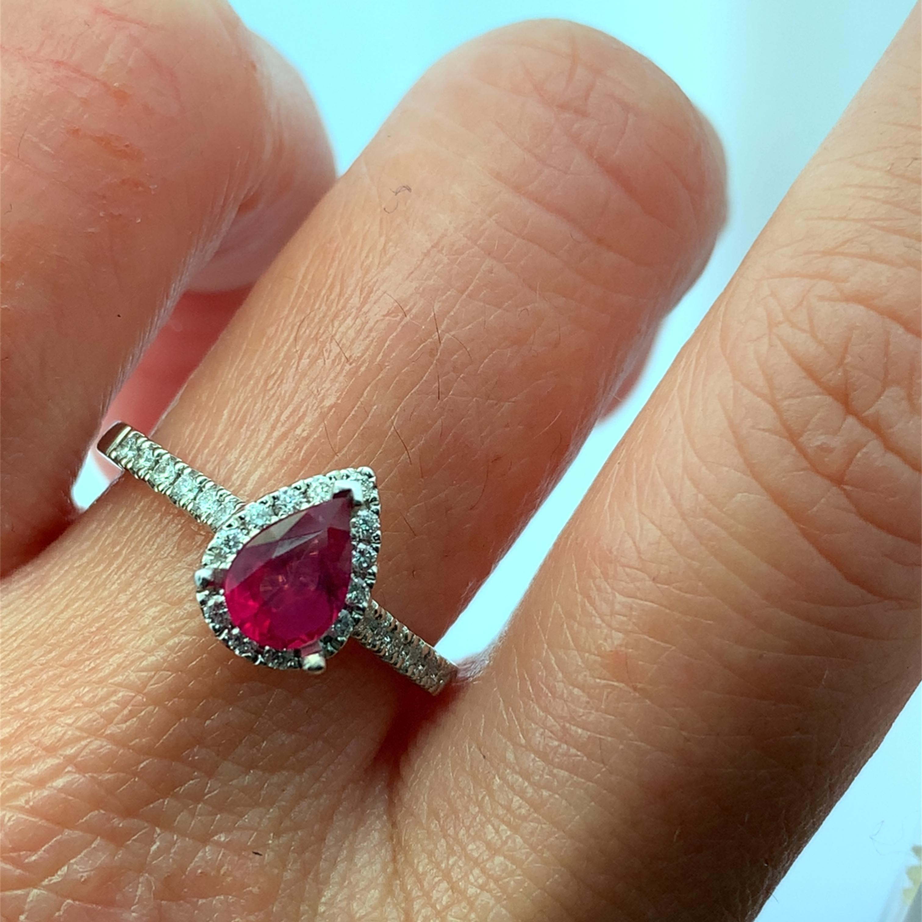 Discover the exquisite beauty of this elegant ruby pear cut 0.90ct and diamond ring. Featuring a stunning pear-shaped ruby at its center, surrounded by a halo of sparkling diamonds 0.80ct F VS1, this piece is perfect for any special occasion.