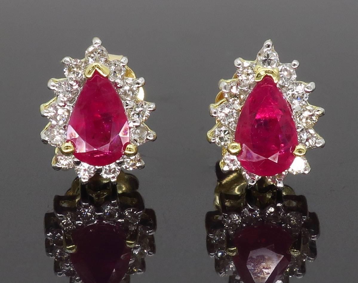 These beautiful earrings feature two pear shaped rubies surrounded by an elegant halo of diamonds. 

Gemstone: Pear Shaped Ruby
Gemstone Carat Weight: 1.00CTW
Diamond Carat Weight: .38CTW
Diamond Cut: 26 Round Brilliant 
Color: G-I
Clarity: Average