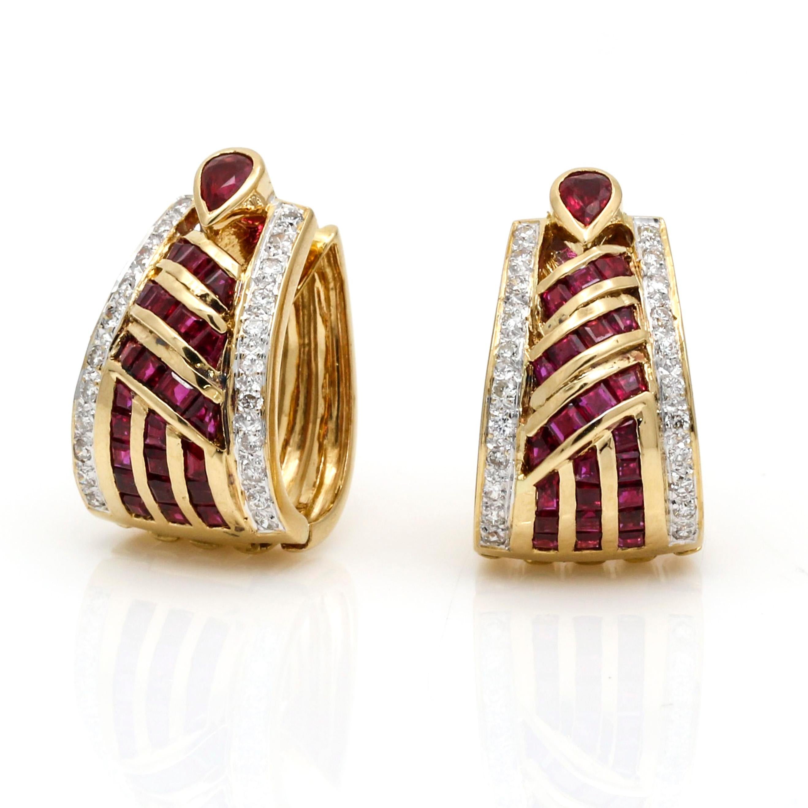 Highlight your timeless beauty with this stunning pair of ruby and diamond earrings. These oval-shaped hinged hoop earrings crafted from 18k yellow gold feature Thailandese rubies with a beautiful red hue, near colorless diamonds, and a polished