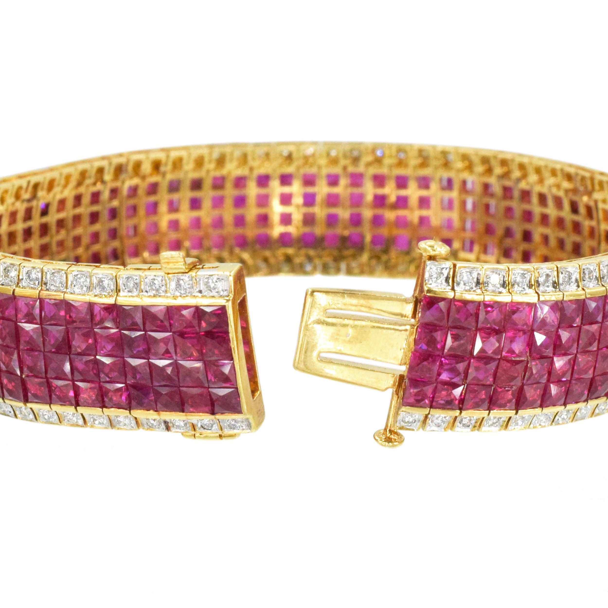 Invisibly set ruby and diamond bracelet crafted in 18k yellow gold. Circa 1990's.
Center features four rows of invisibly set rubies, accented with a row of round brilliant
cut diamonds on each side. There is total of 300 square cut rubies with