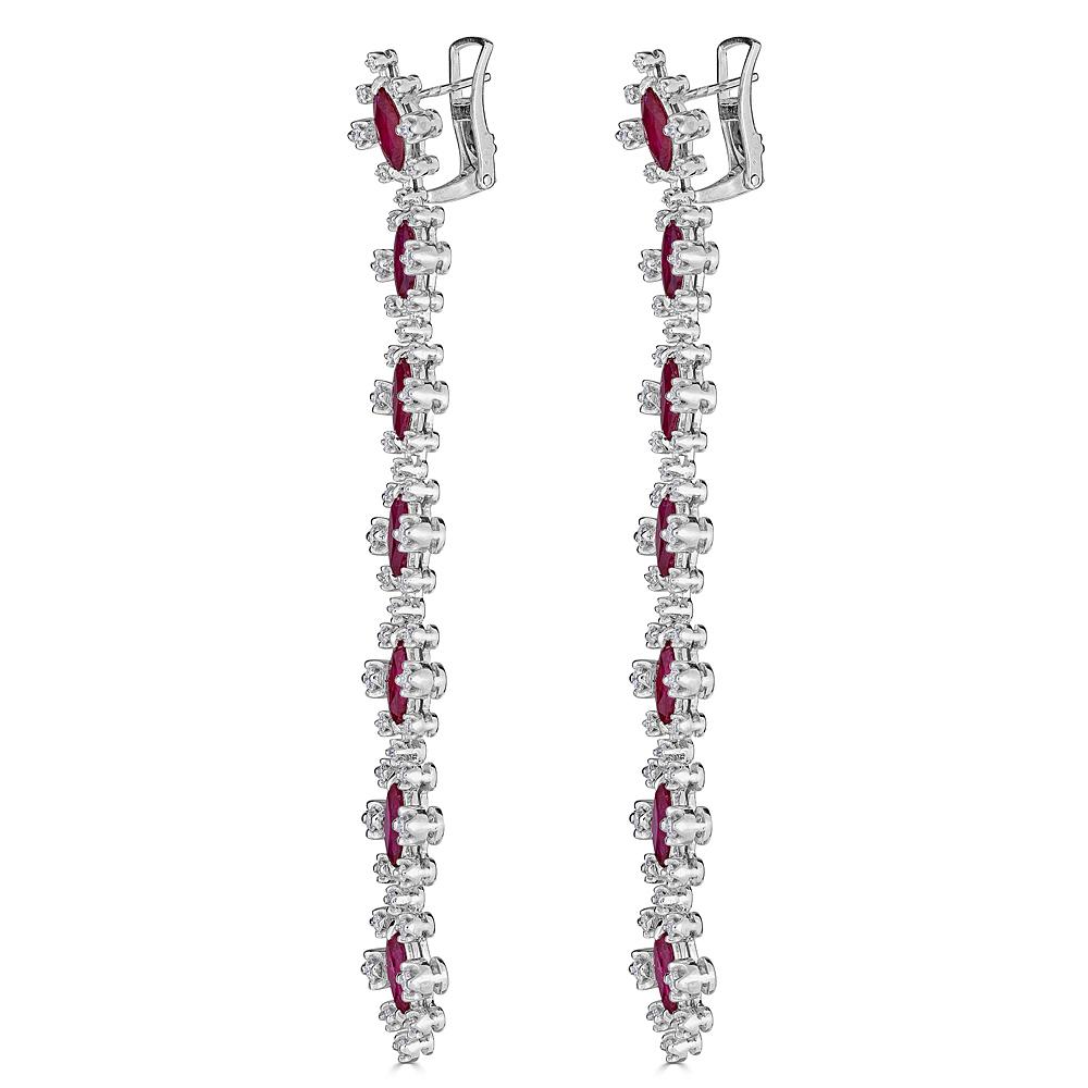 A pair of Line earrings with Beautiful Ruby and Diamonds. Handcrafted in 18k white gold and suspended from a hidden post and omega back, these earrings feature 2.60 carats of prong set Round Brilliant Cut Diamonds and 10.65 carats of Natural