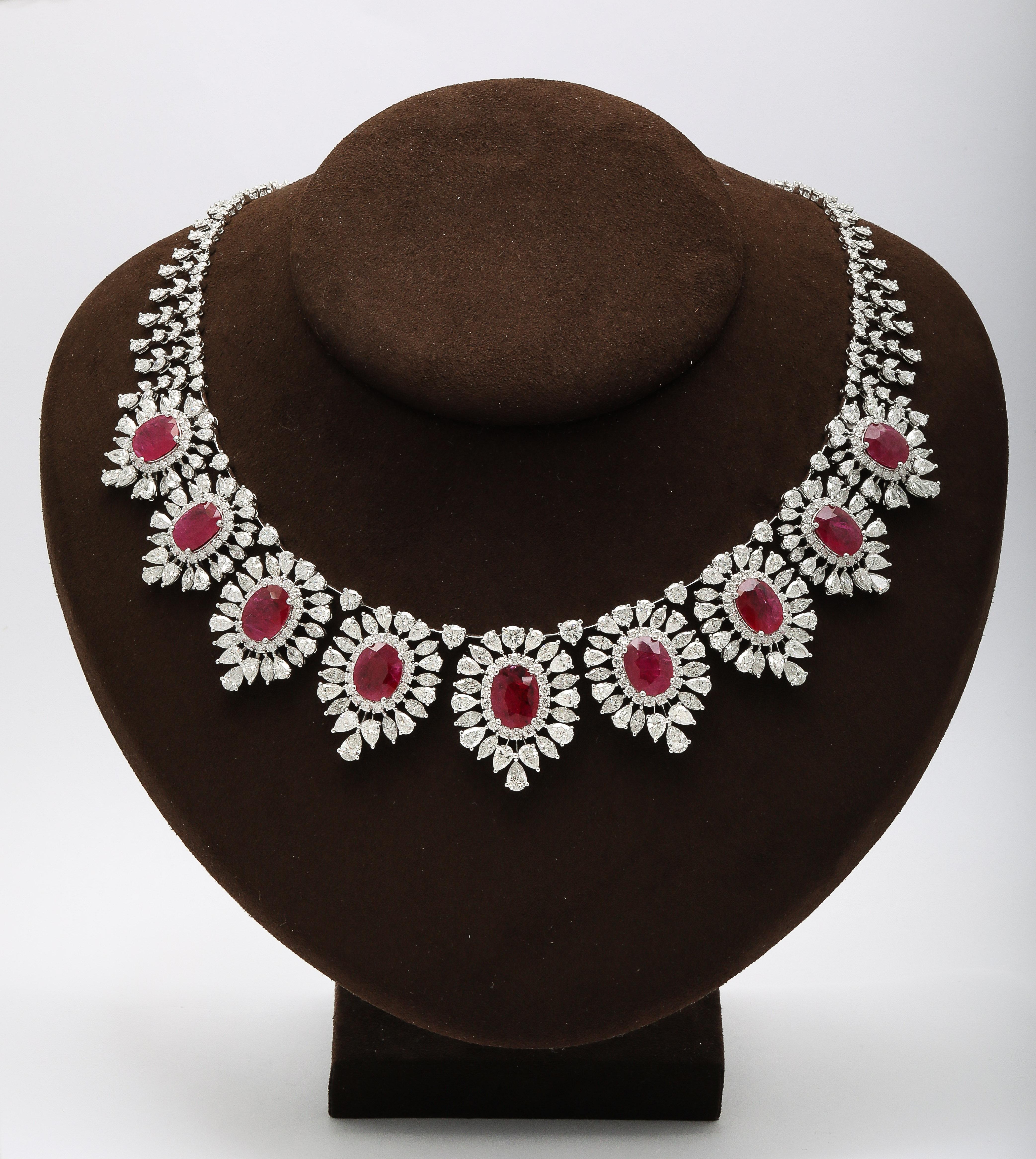 
An exceptionally made Ruby and Diamond Necklace. 

33.29 carats of certified Intense Red oval Ruby. 

44.36 carats of white round, pear and marquise cut diamonds. 

Set in 18k white gold. 

Approximately 16.5 inch length. 

Matching earrings are